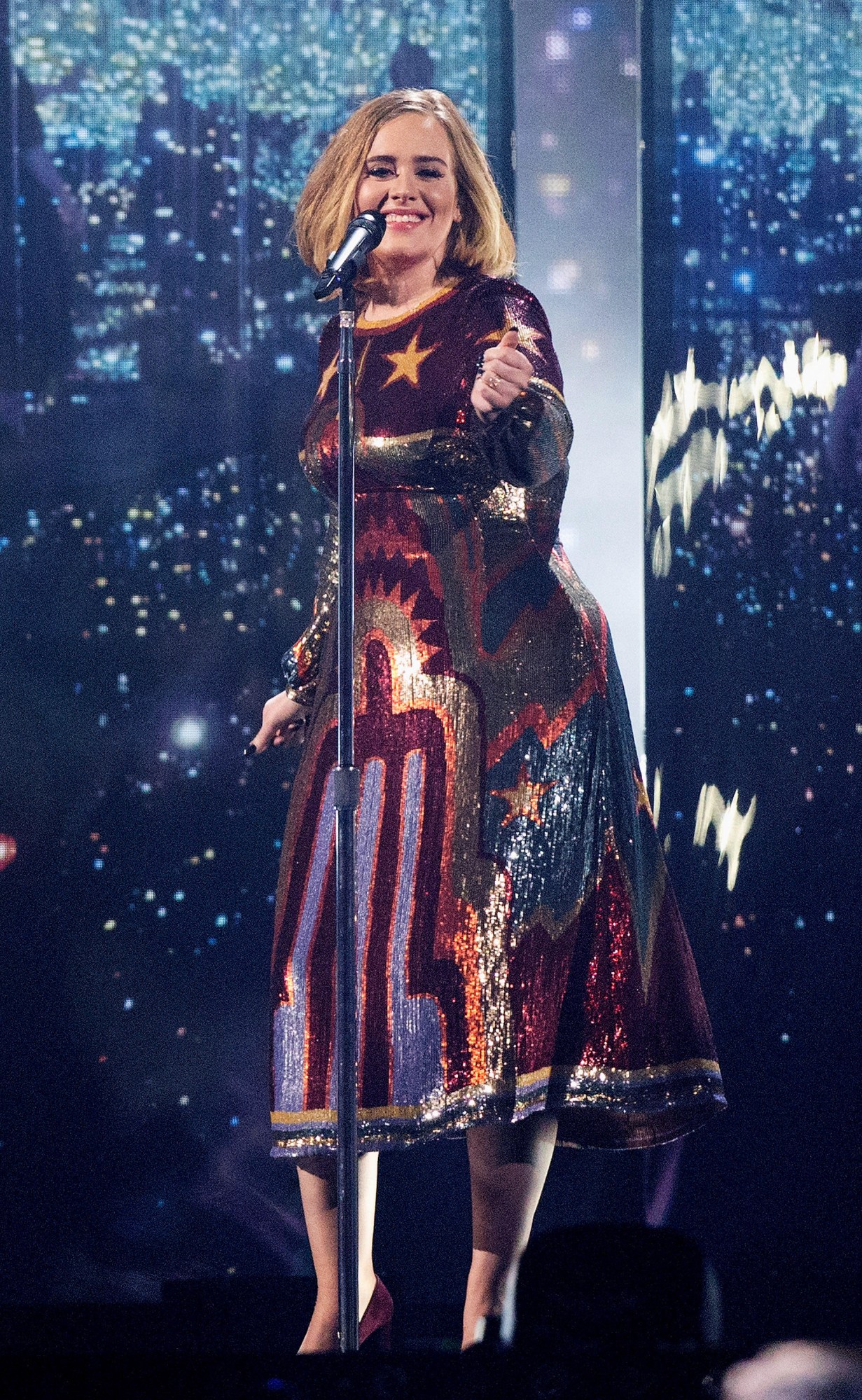 adele in a sequinned dress performing at the brit awards in 2016