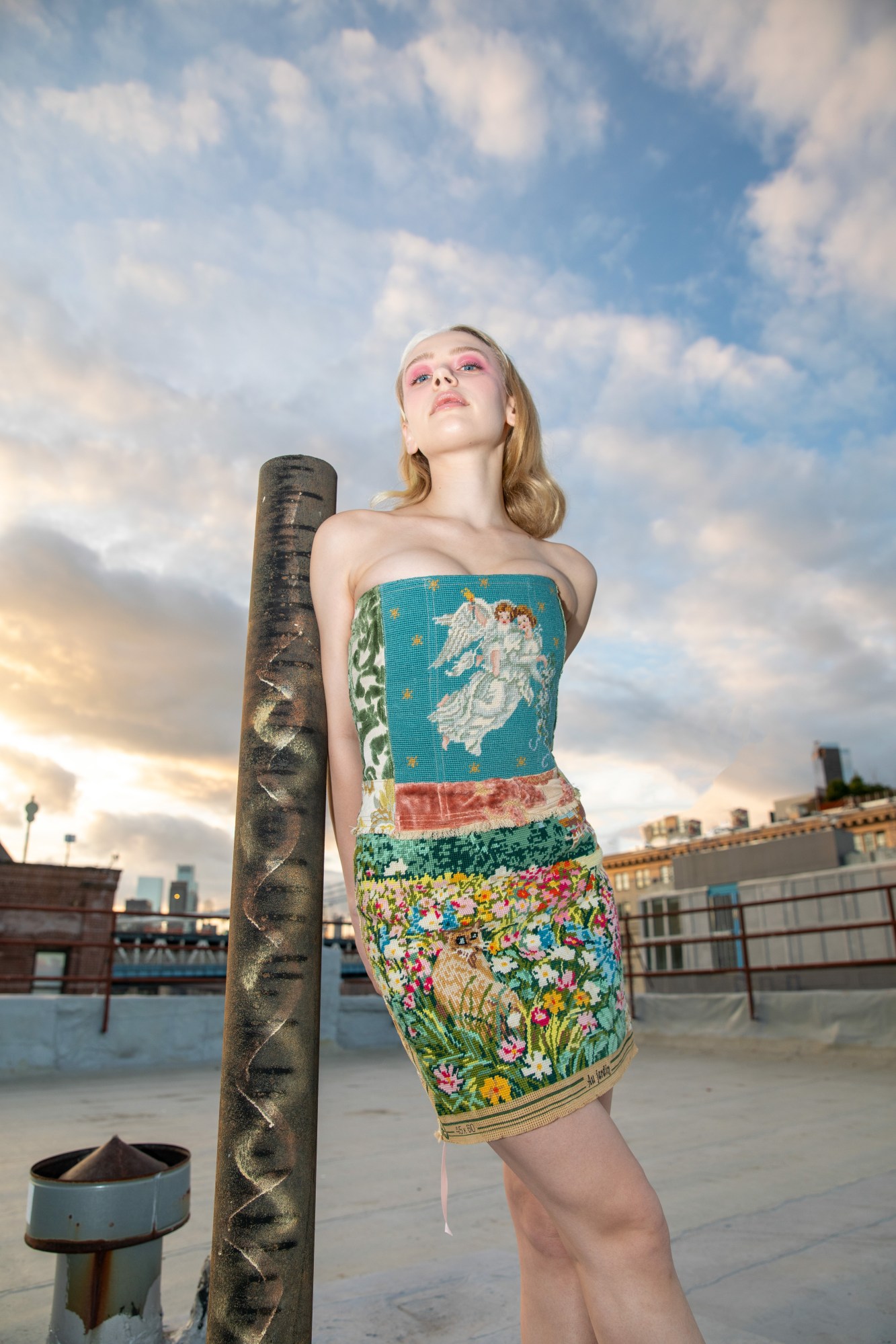 tia jonsson posing on a rooftop in a tapestry corset and skirt by kristin mallison