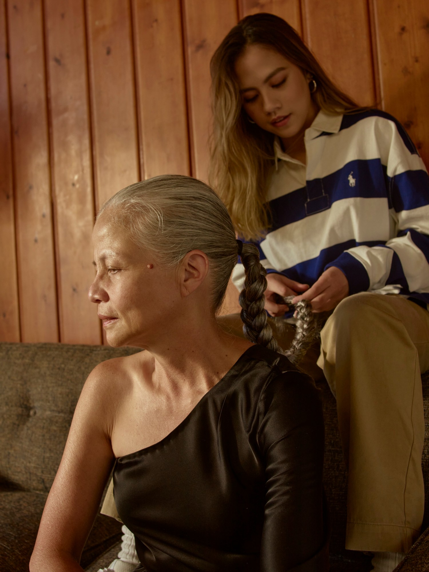 Emman's sister plaiting her mum's hair, both wearing Polo Ralph Lauren.