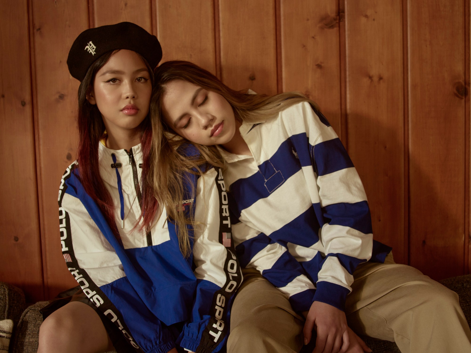 ​Emily wears Polo Ralph Lauren jacket and beret as her sister in a striped polo and tan chinos lays on her shoulder