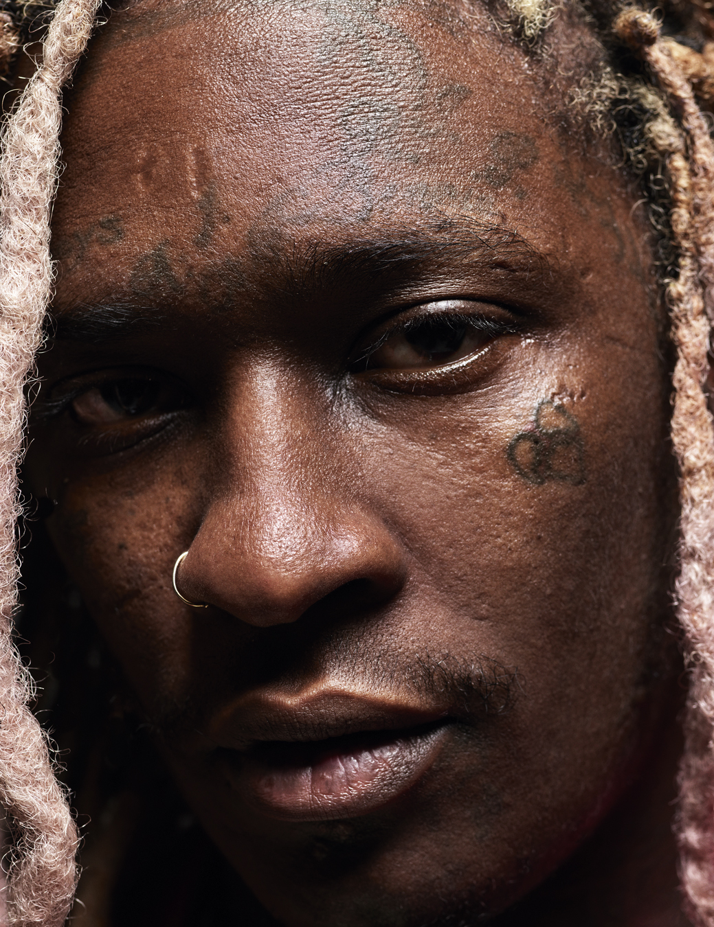 Close up of Young Thug's face with a nose ring.