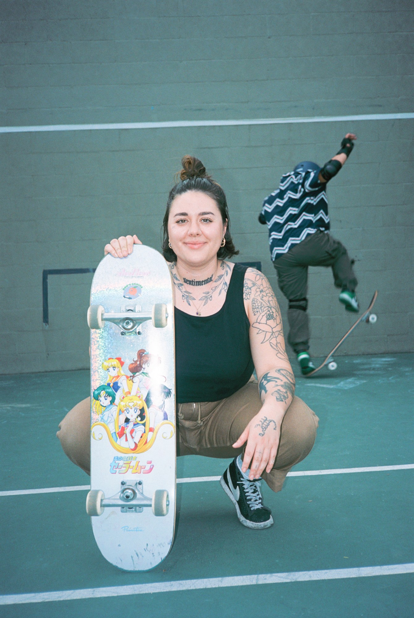 roni davis posing with her sailor moon skateboard at the park