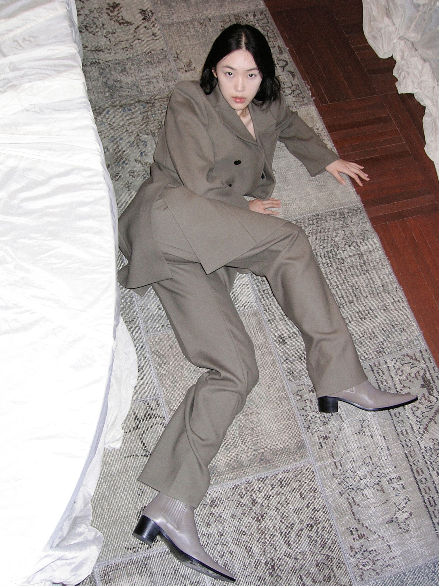 A model wearing Peter Do and lying on the floor