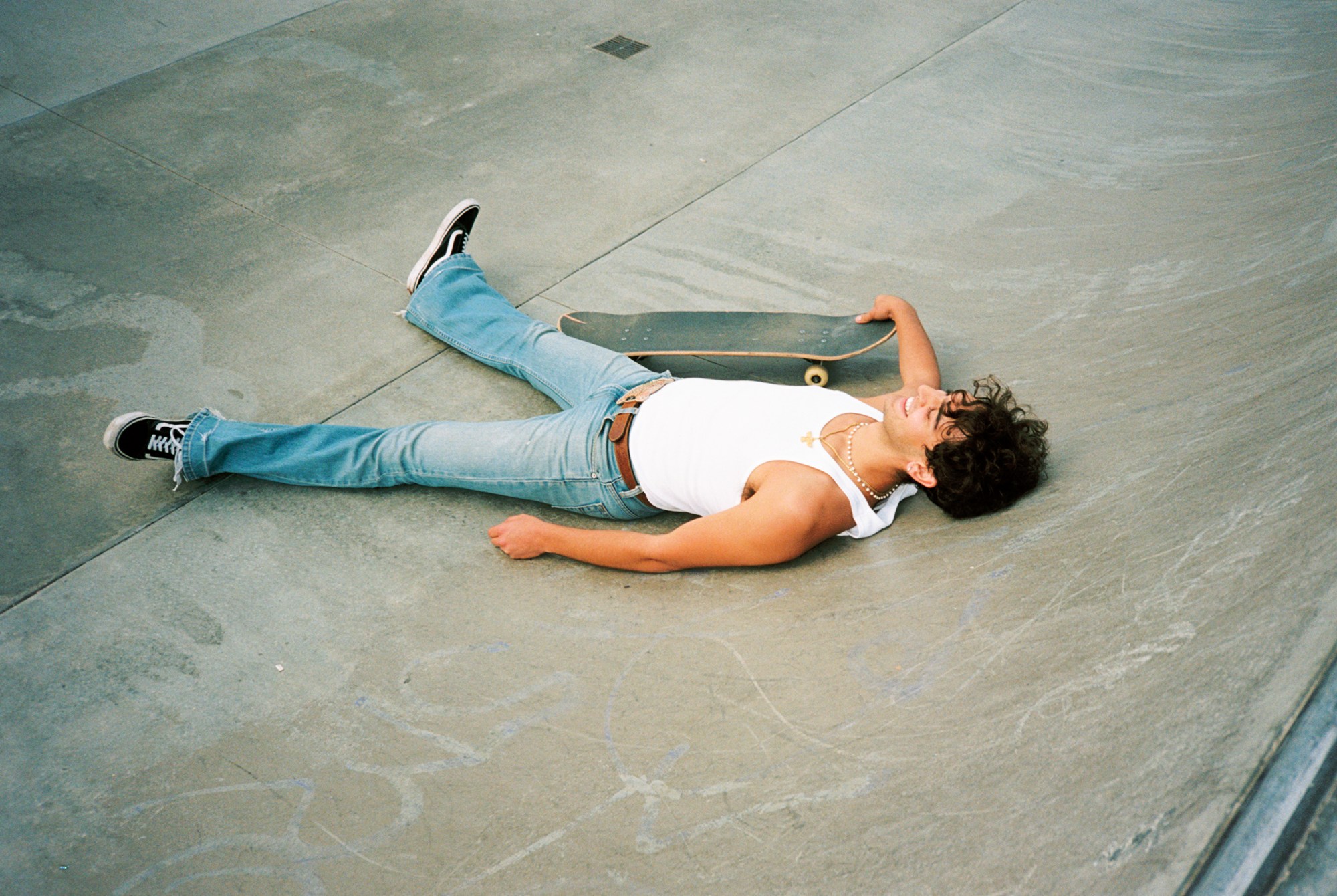 arian rad of skate collective boos cruise lying on a ramp with his board