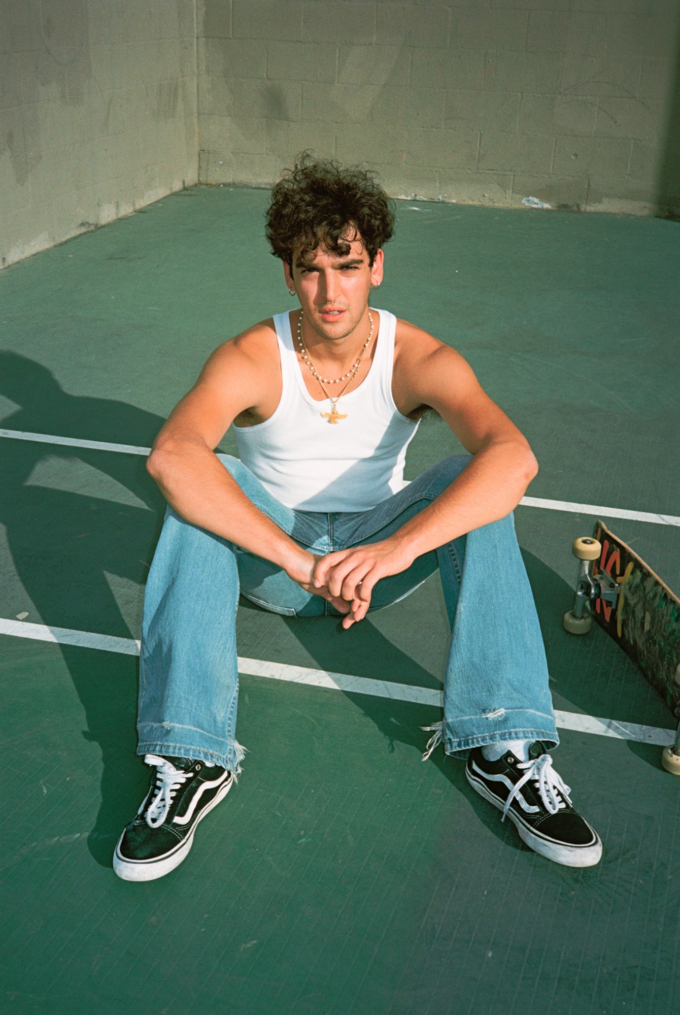 arian rad sitting with his hands clasped at the skate park