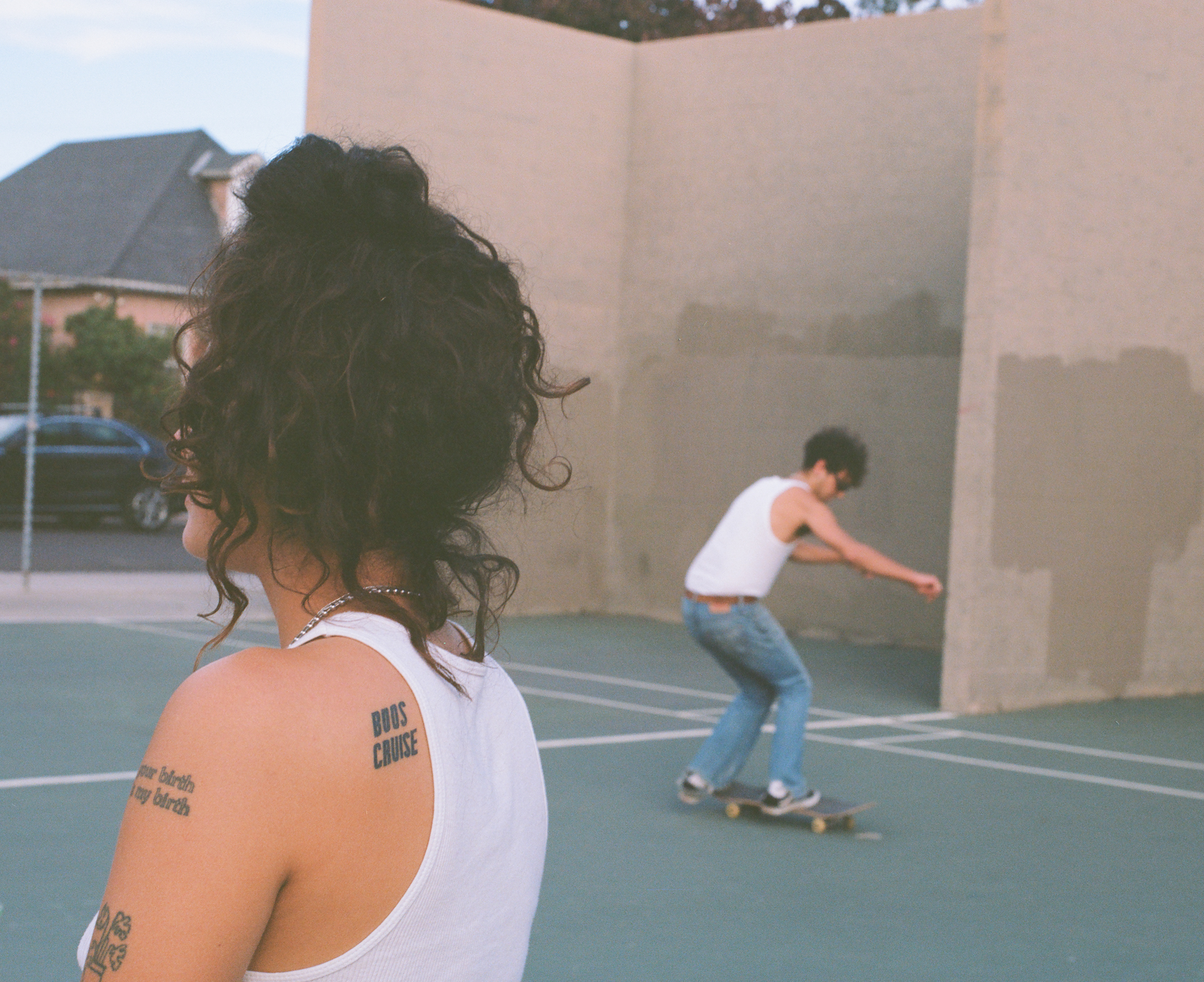 a side profile of yaya chavez and their boos cruise tattoo at the skate park