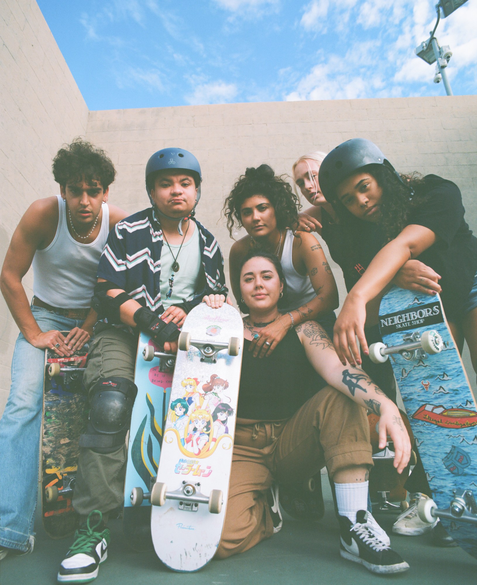 members of queer skate collective boos cruise posing at the park in los angeles