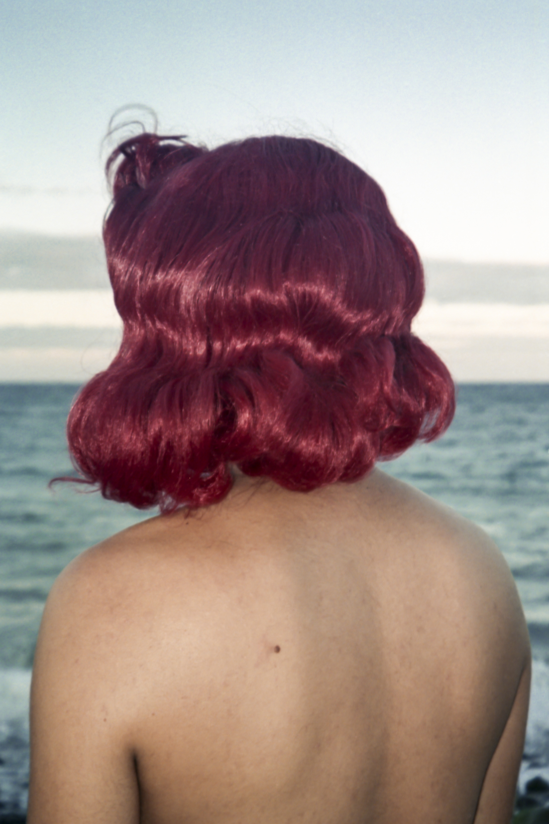 the back of someone's head with red curly hair