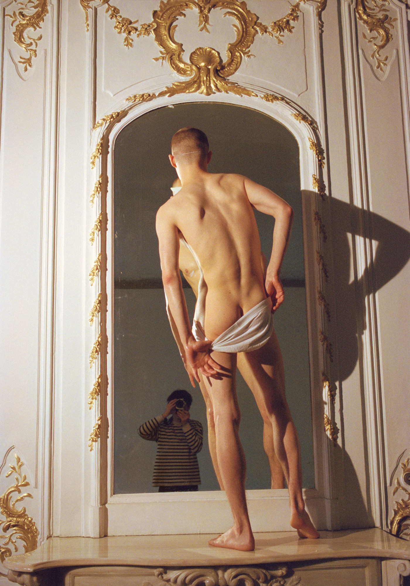 vlad zorin's portrait of a man in a gold framed mirror, pulling his pants down