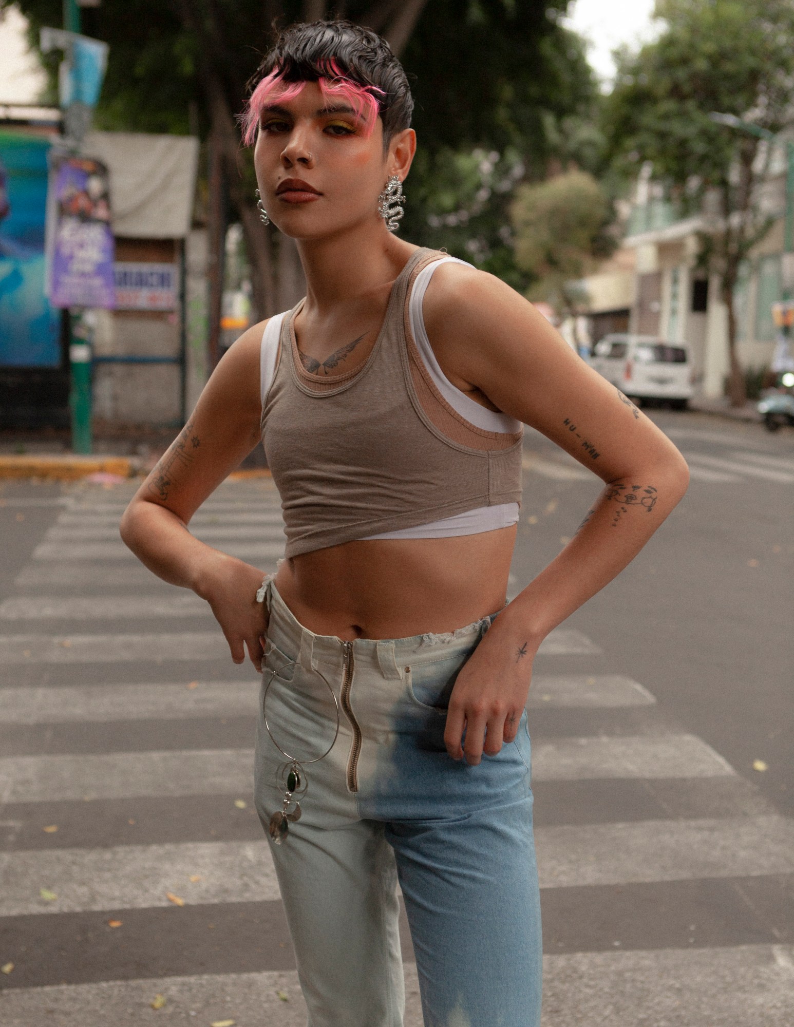 a portrait of melon rivas standing in the street in mexico city