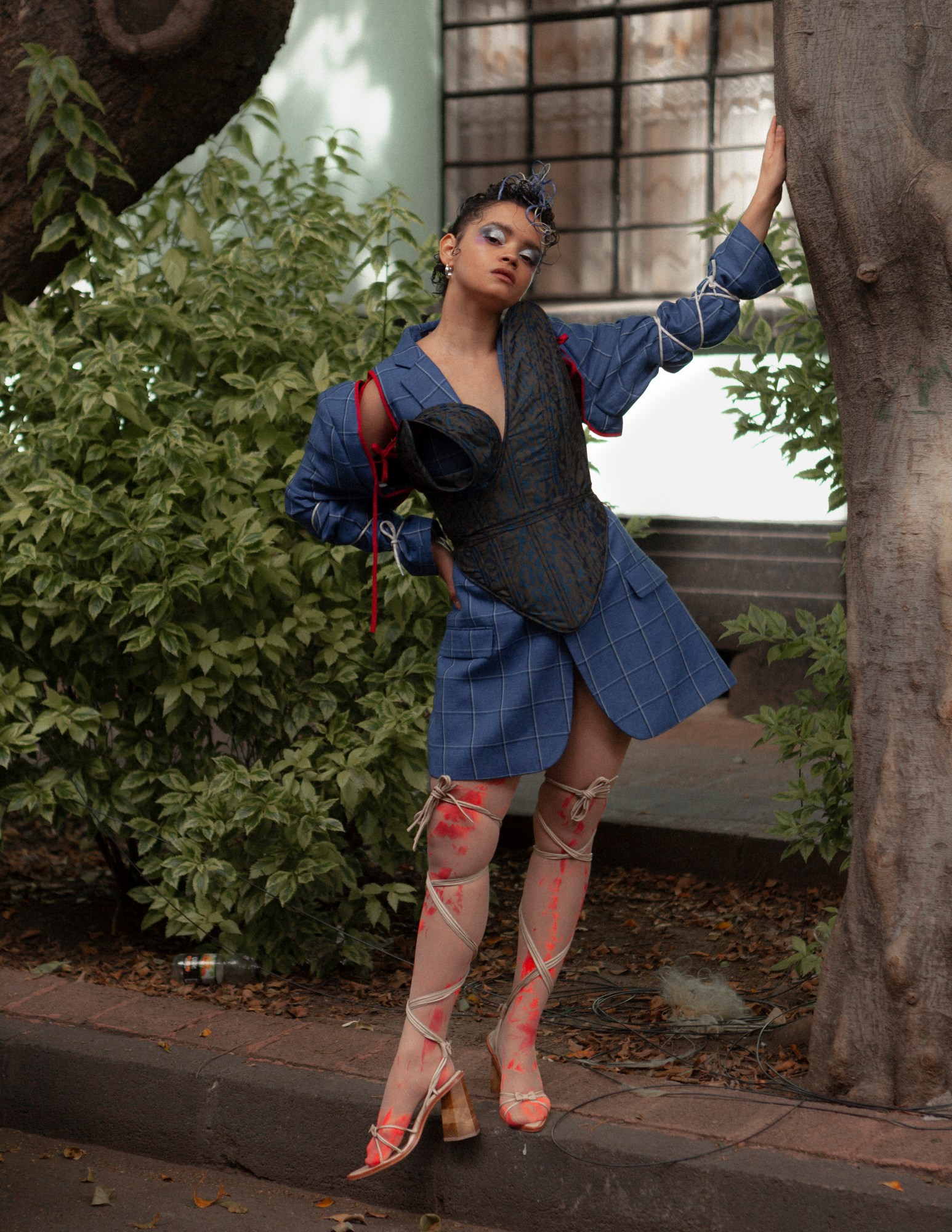 a model posing under a tree in mexico city