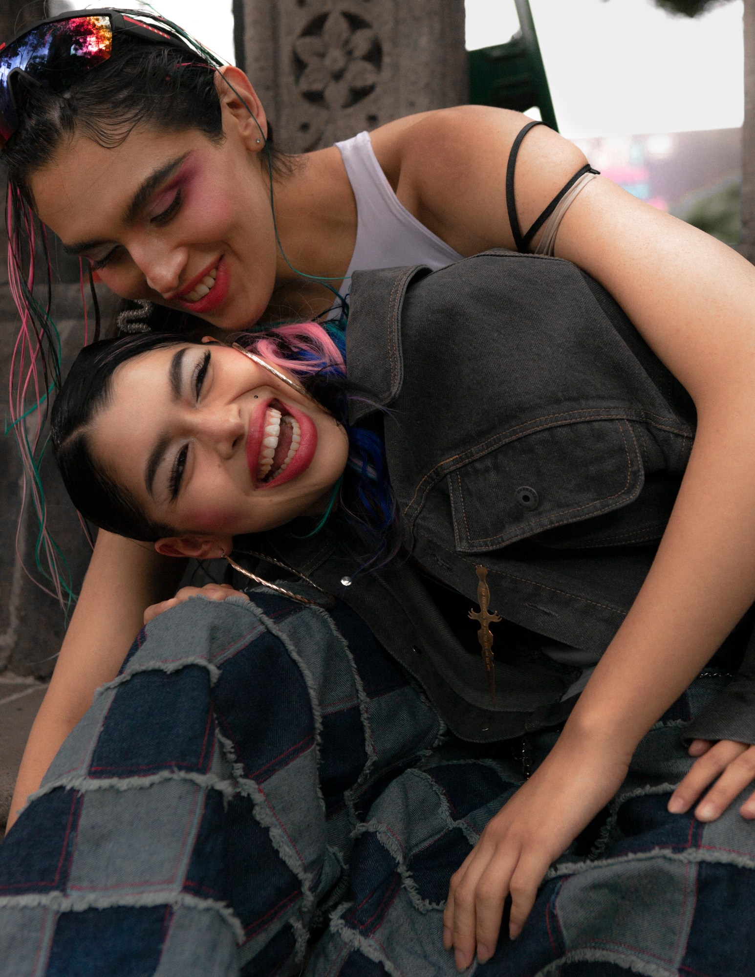 two models julie and ana laughing and embracing in mexico city