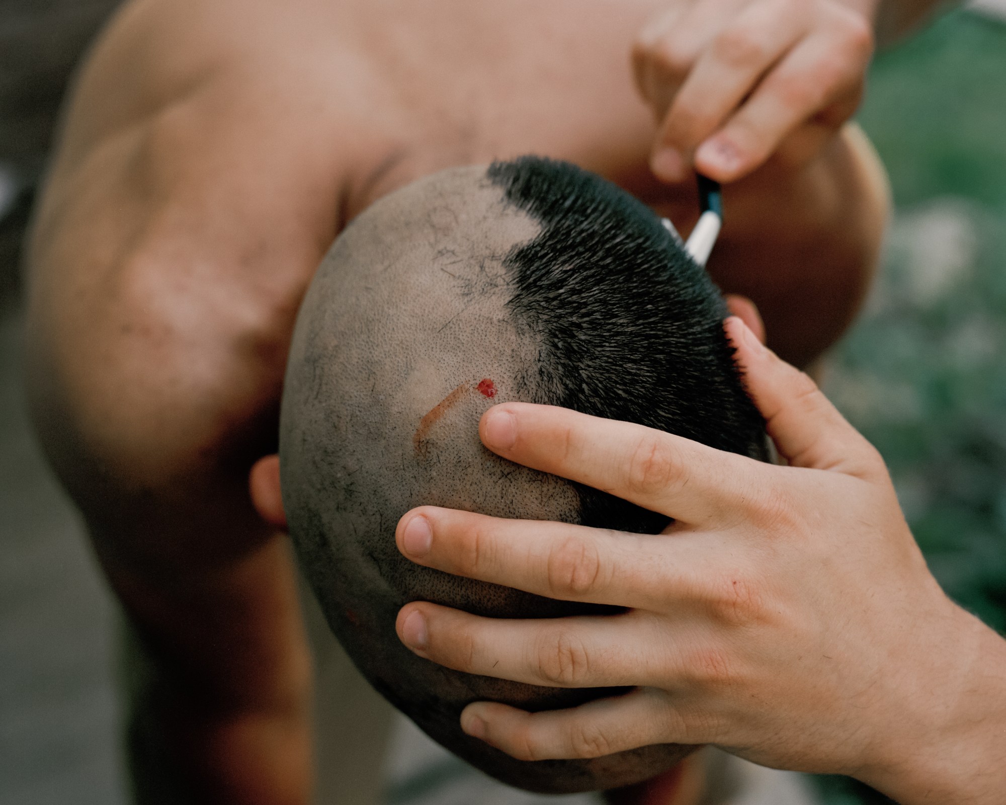 a man's head being shaved