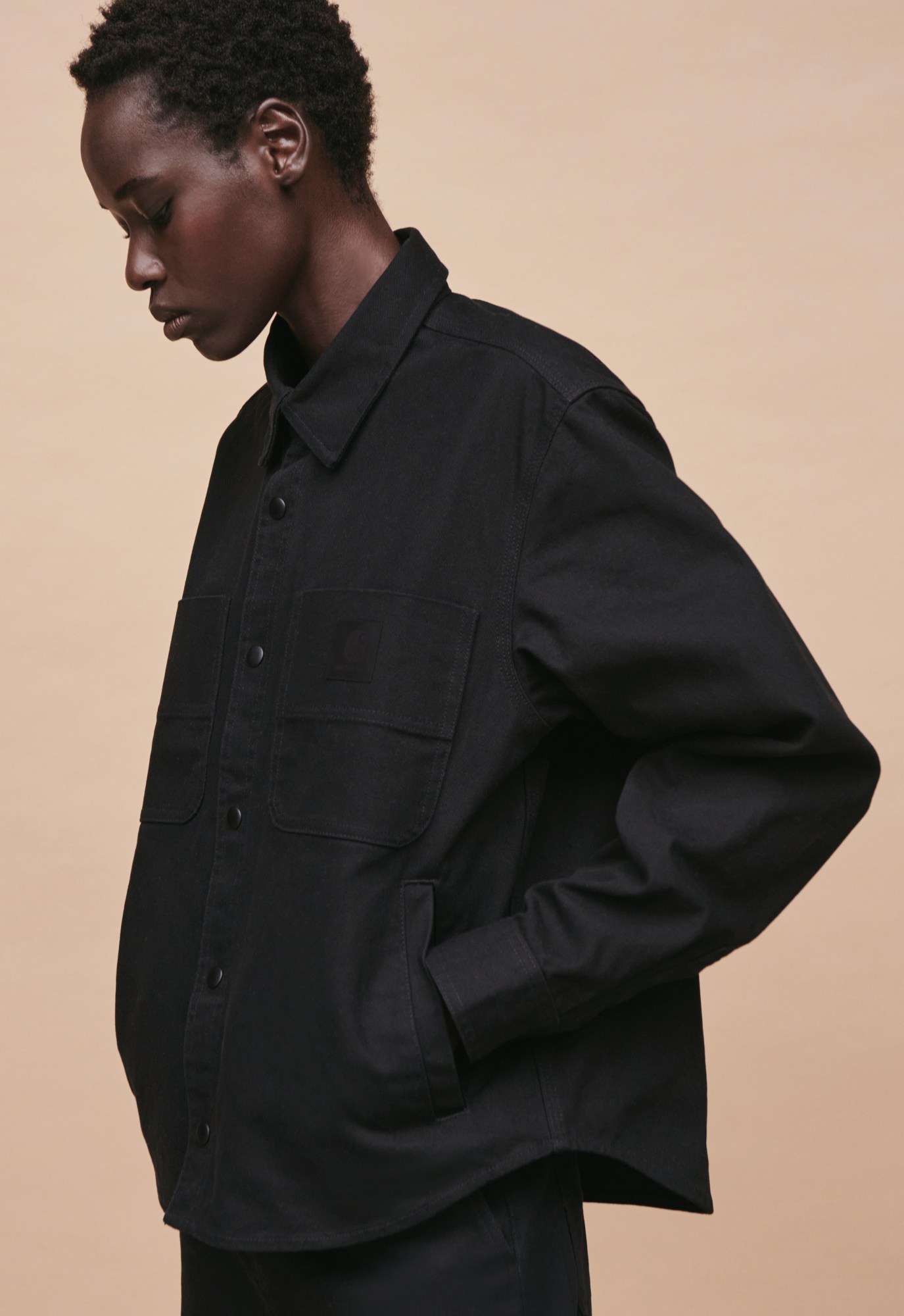 A model wearing elegant all black workwear