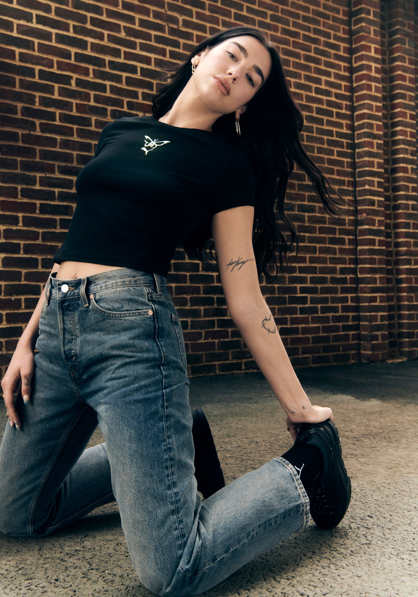 Dua Lipa poses wearing her new Flutur x PUMA collection