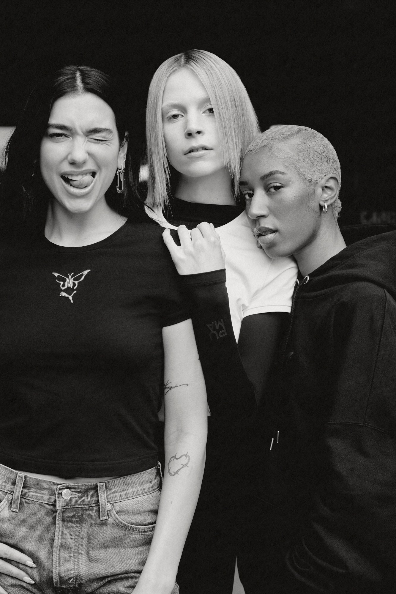 Dua Lipa poses with models Charley Dean Sayers and Sharkkana