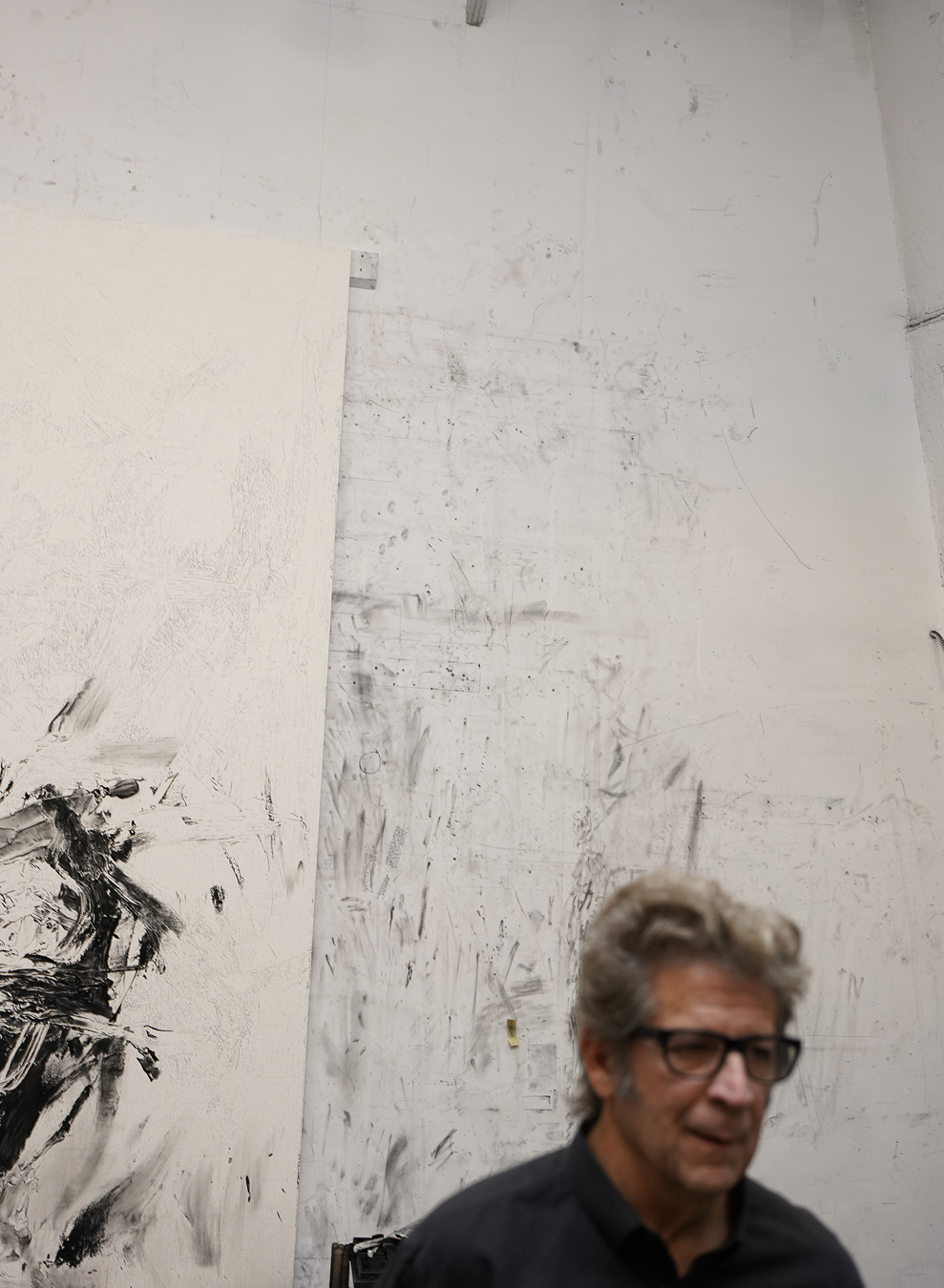 Robert Longo stands in front of his artwork.