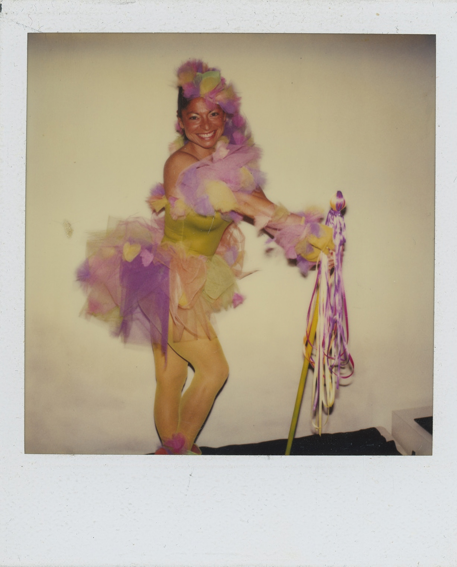 a dancer in a tulle-covered leotard poses with a baton at paradise garage