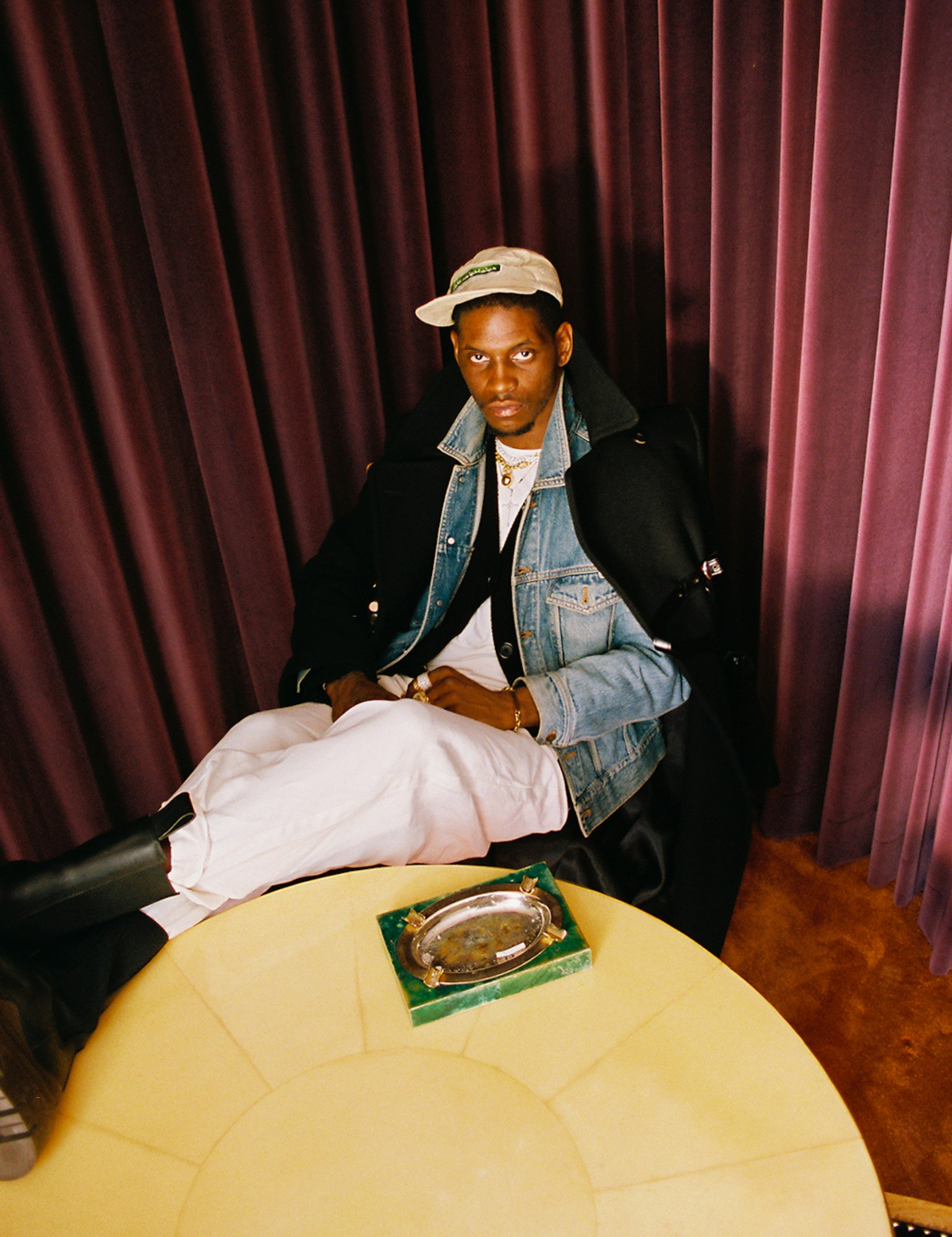 A$AP Nast sitting on a chair with his boots on a table photographed by Bladimir Corniel