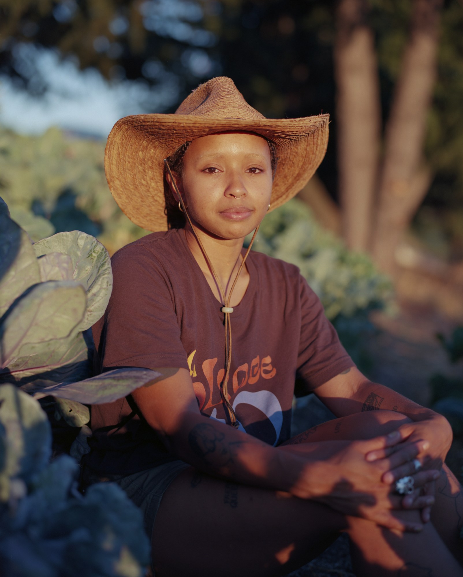 simone dawson sitting with their hands folding in front of cabbage