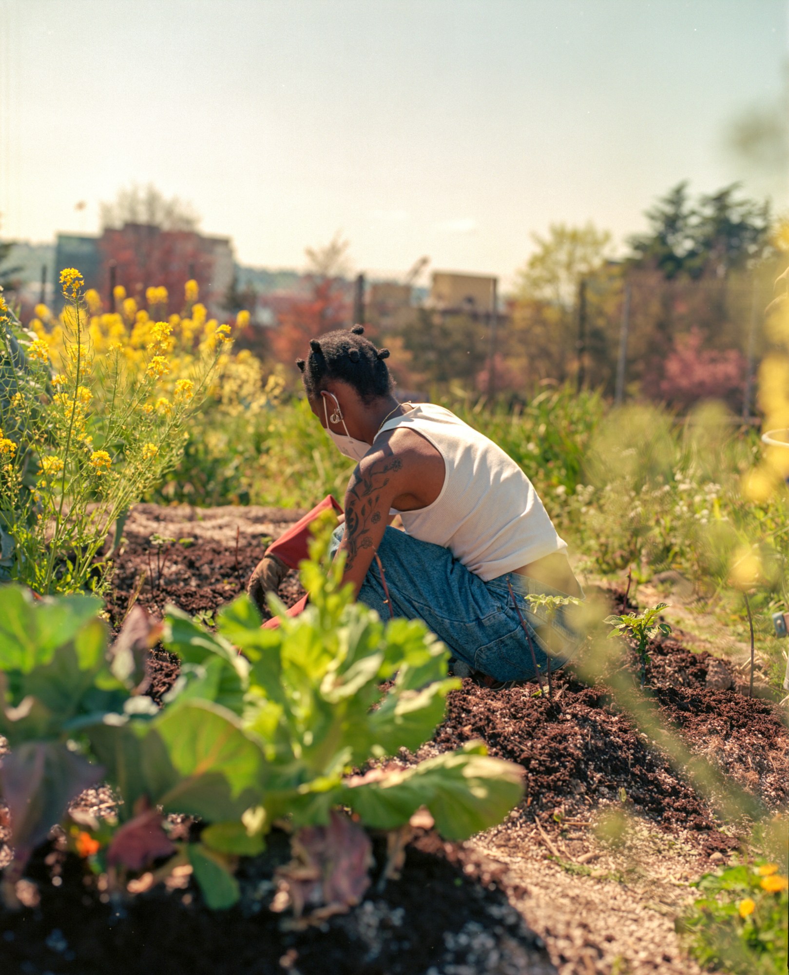 a girl with tattoos gardening on the farm