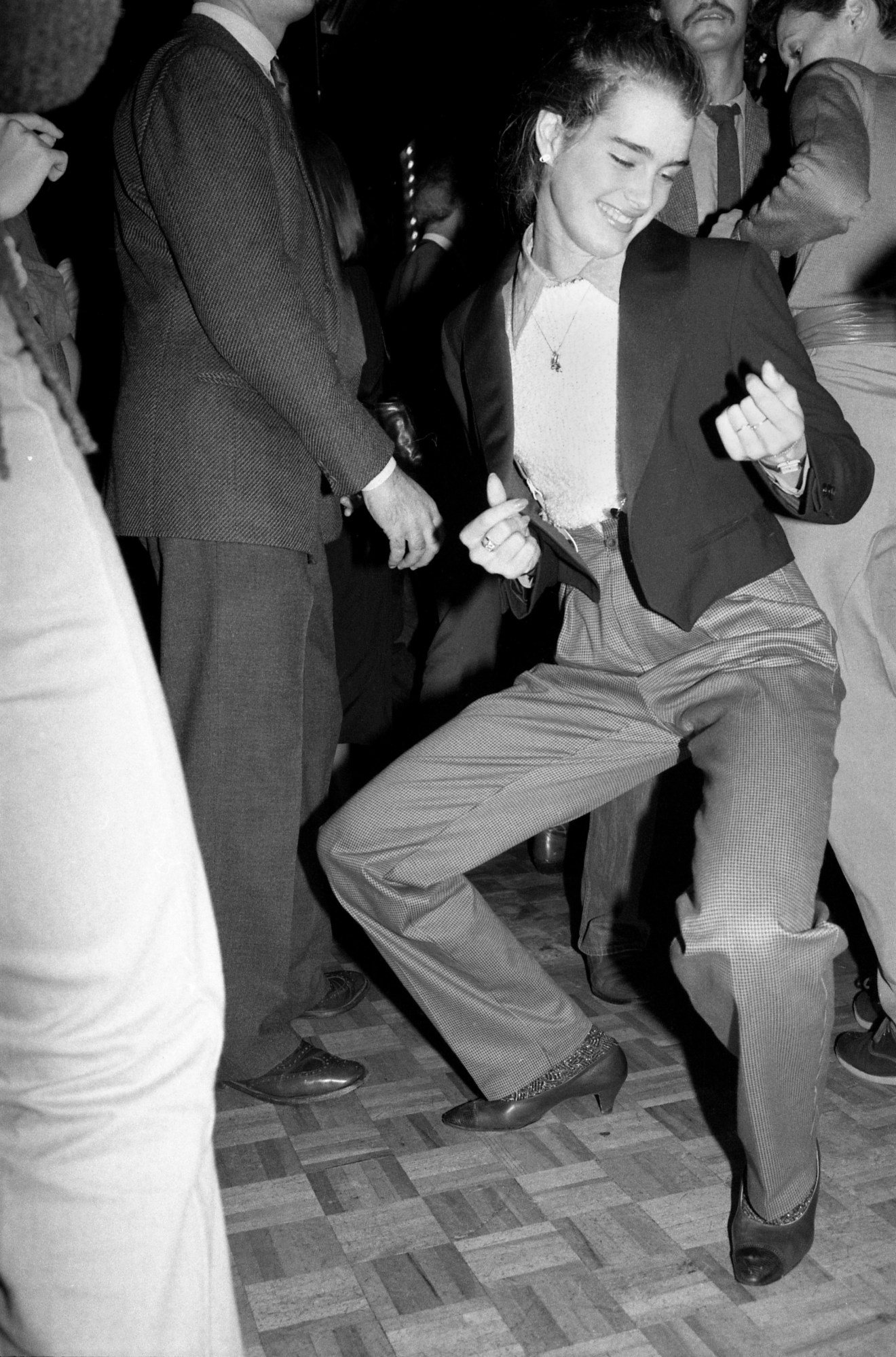 brooke shields dancing in a suit jacket and trousers at studio 54 in 1979