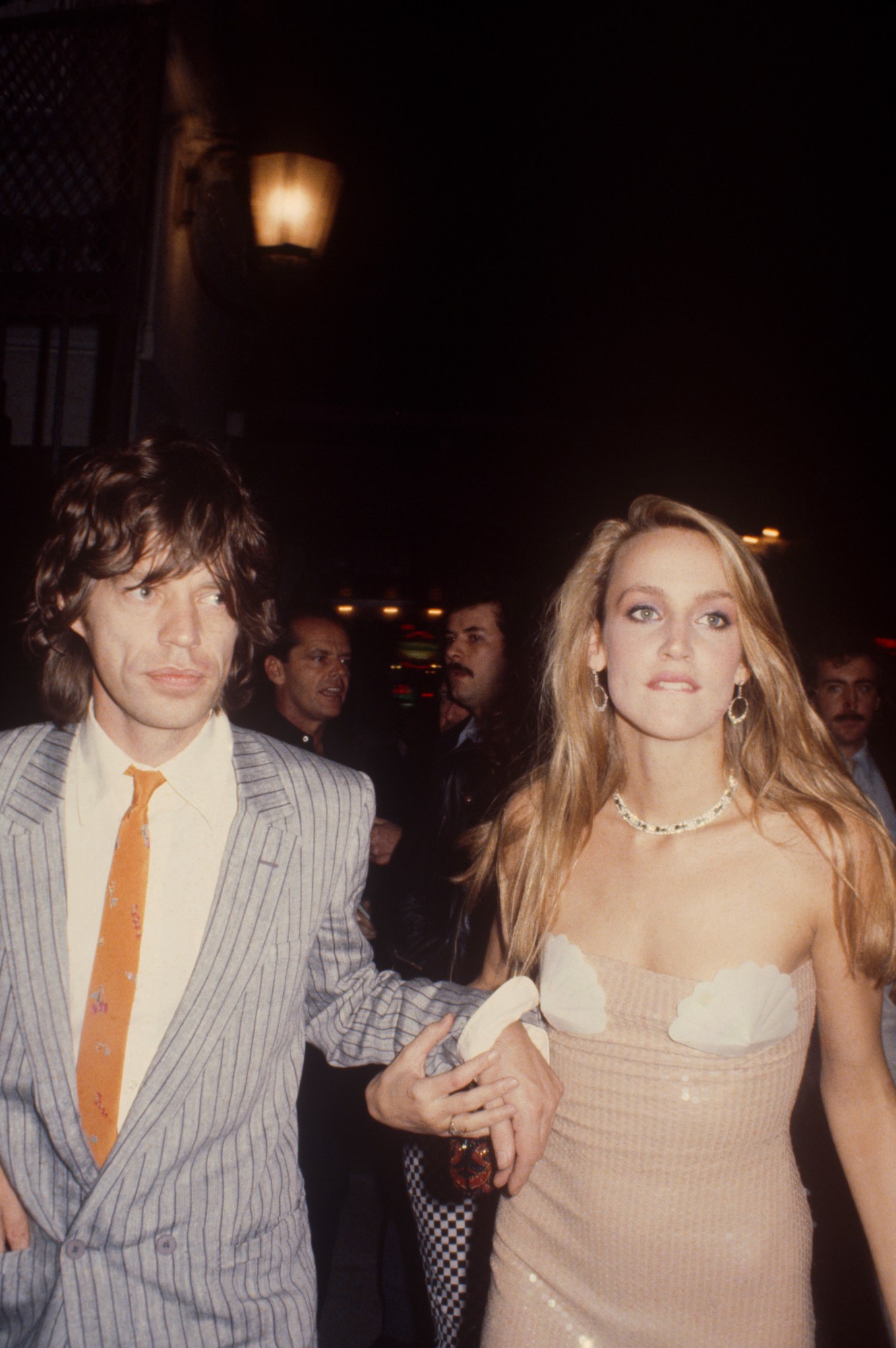 jerry hall in a sequin mermaid dress and mick jagger in a pinstriped suit 1981