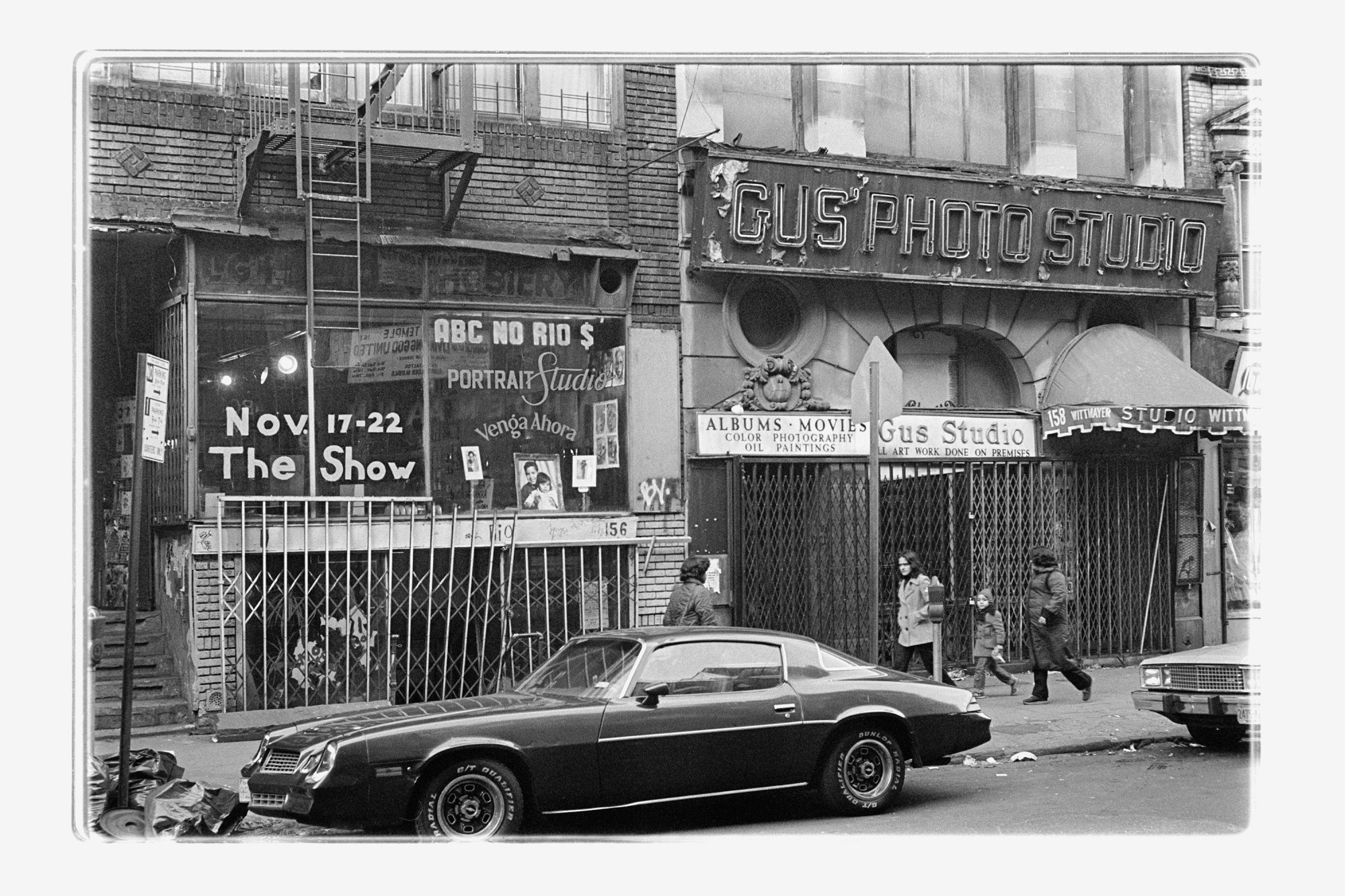 a black and white photo of a car outside ABC No Rio on Rivington Street in New York 1981