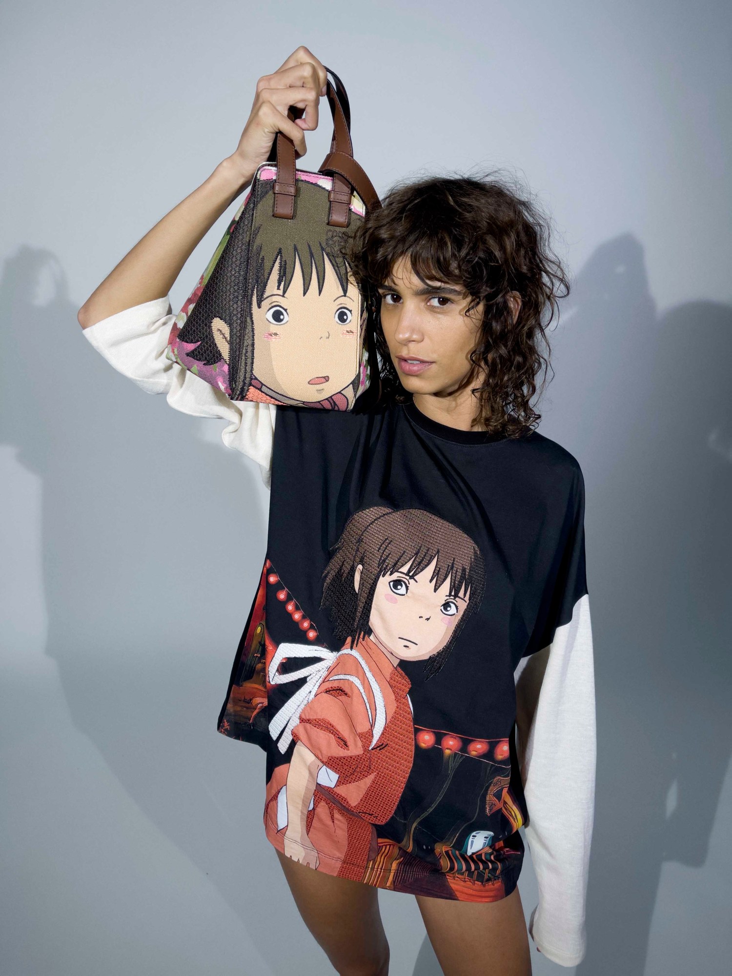 Model wears LOEWE top and bag with main character from Spirited away