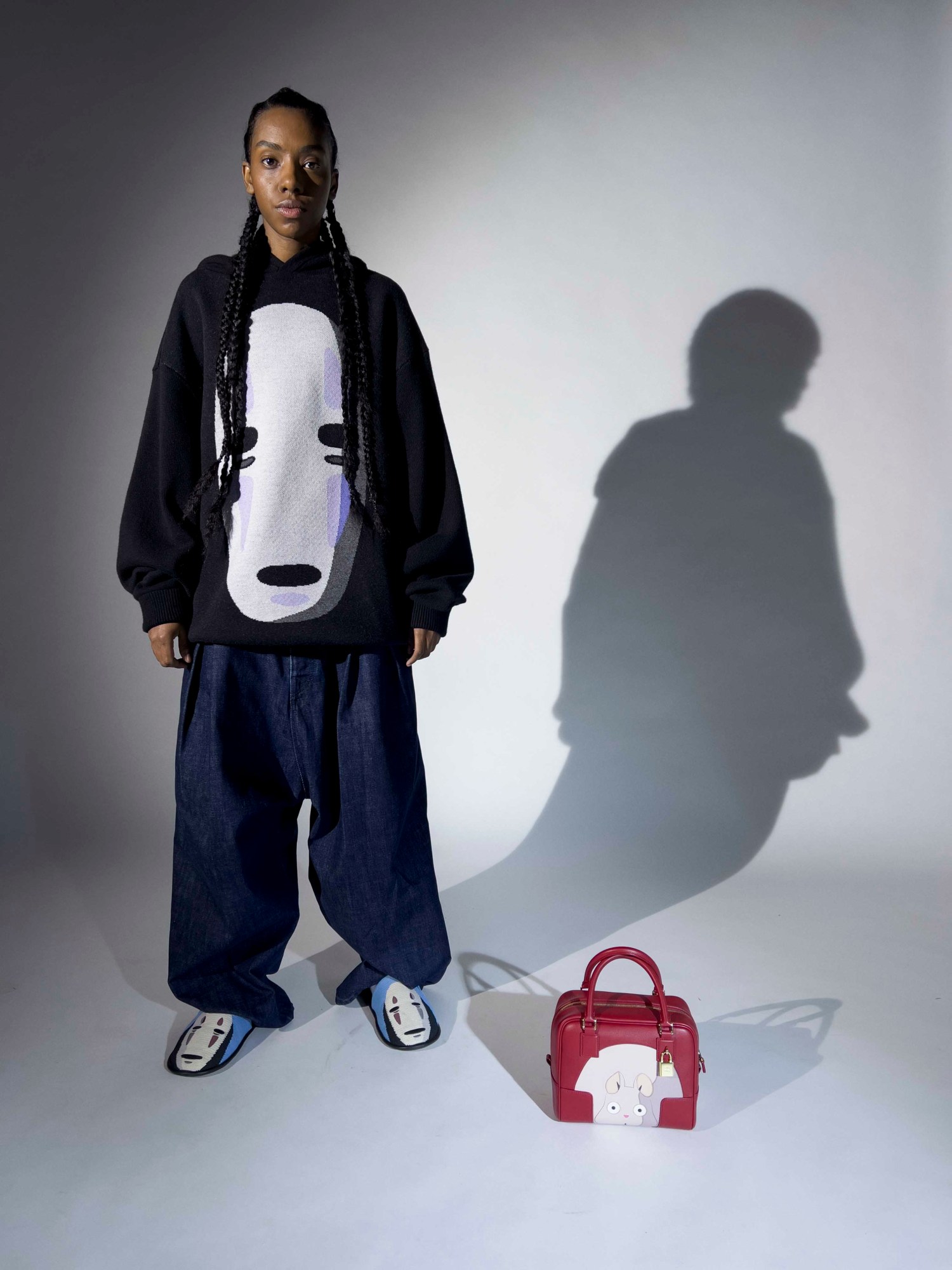 Model wears LOEWE top, shoes and bag with characters from Spirited Away