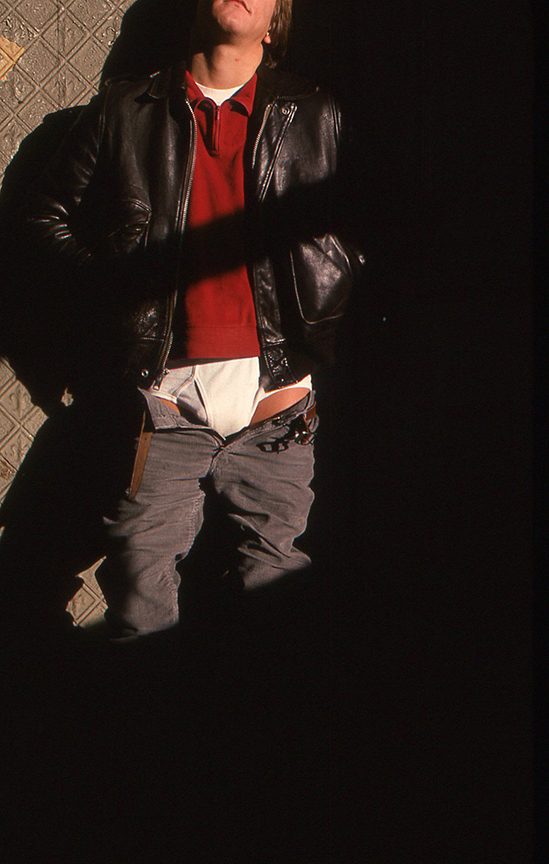 a photo of a man with his pants unbuttoned at christopher street pier in the 70s