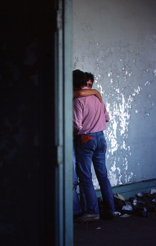 two men kissing and embracing at christopher street pier in the 1970s