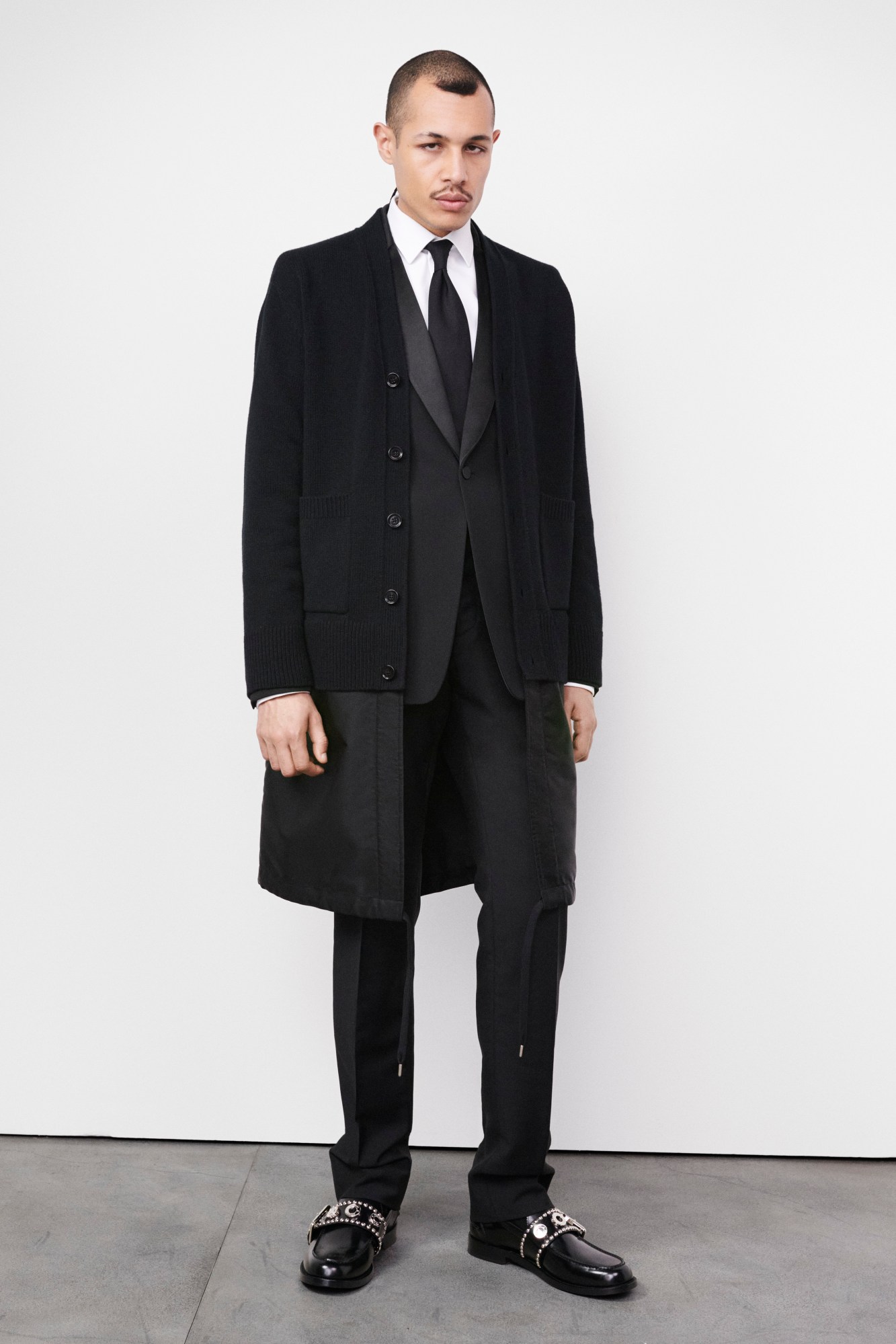 Models wearing black cardigan suit and buckled shoes for Burberry's AW22 precollection