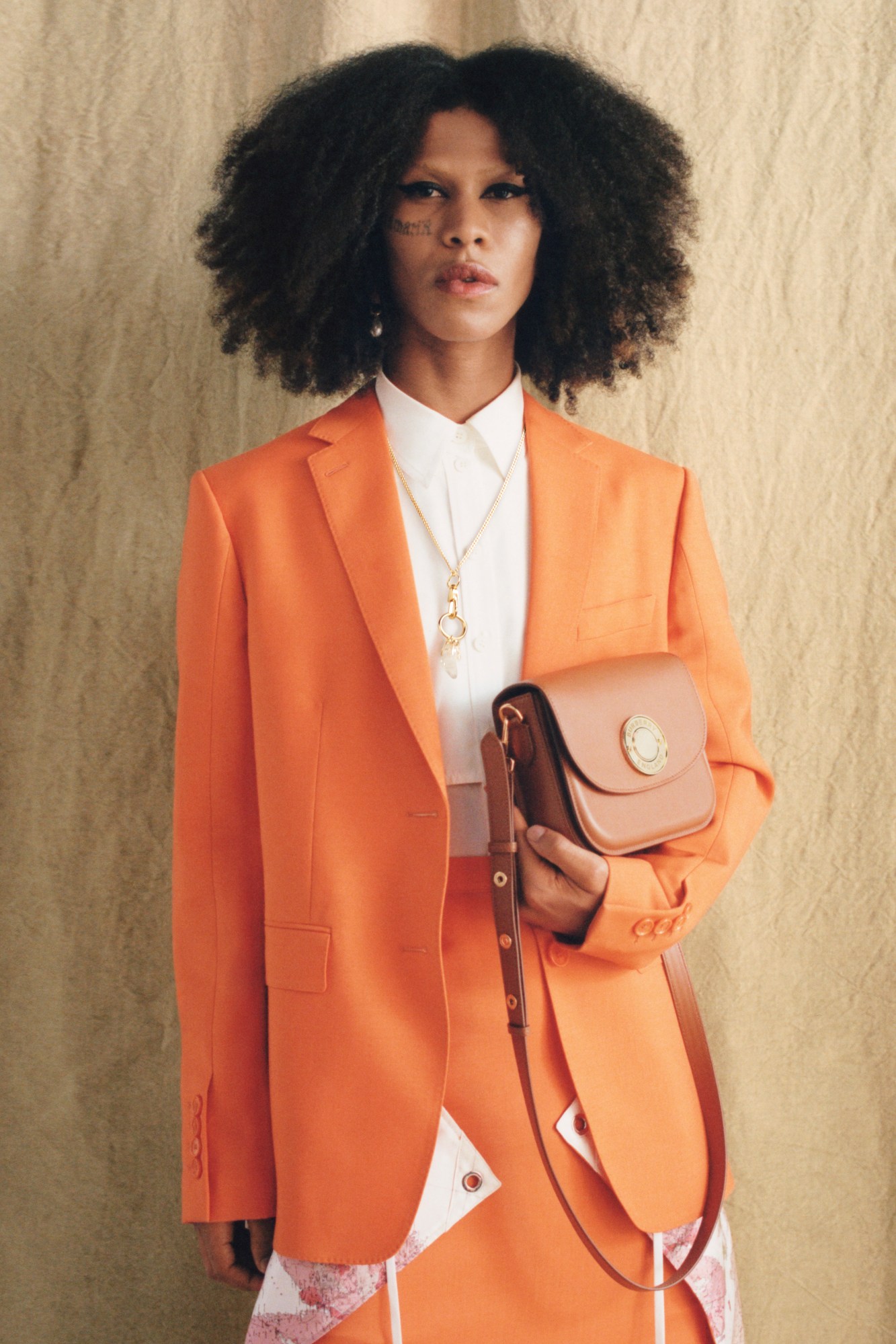 Models wearing orange suit Burberry's AW22 precollection