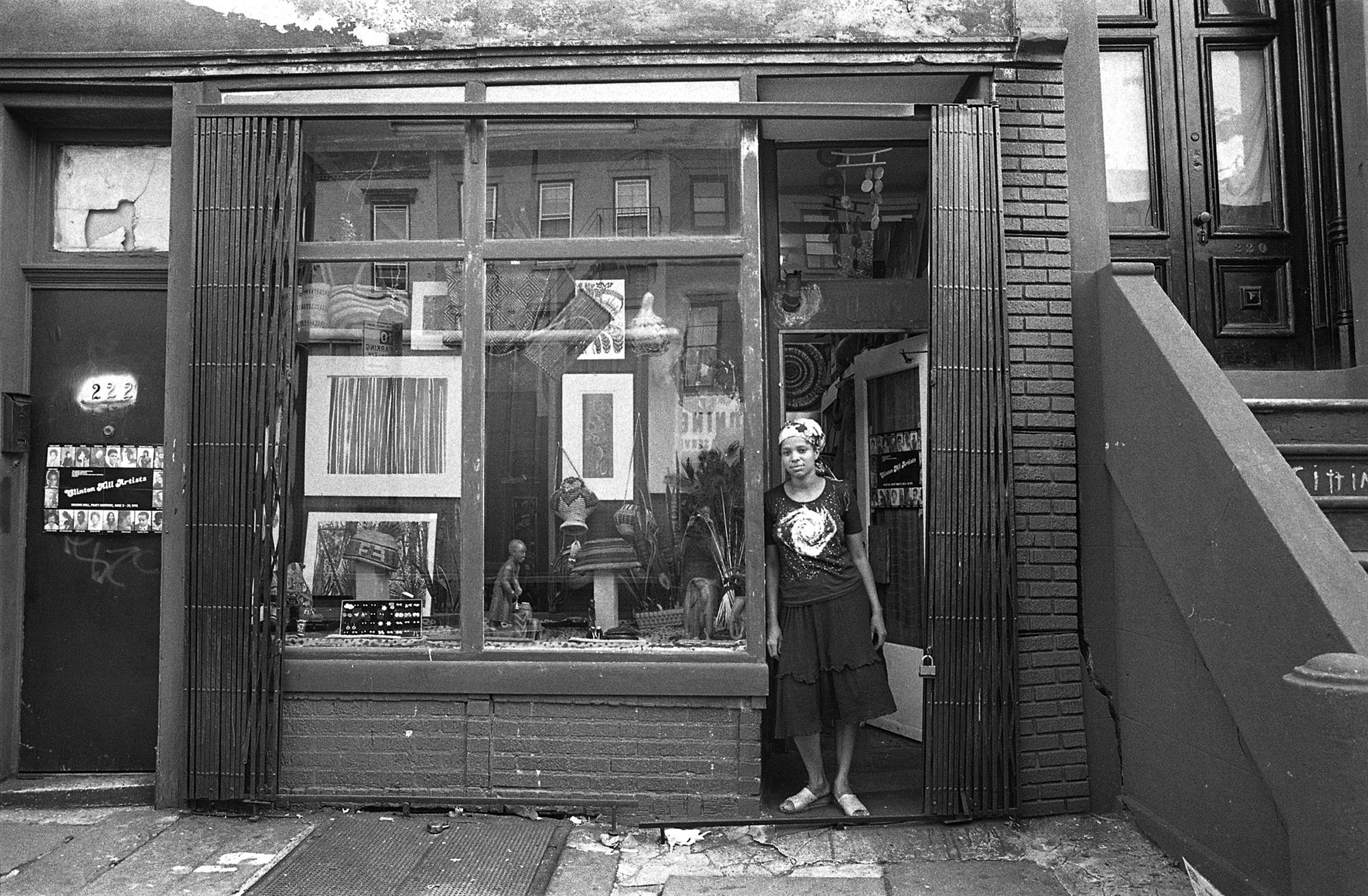 a person stands in the open doorway of a shop or gallery space