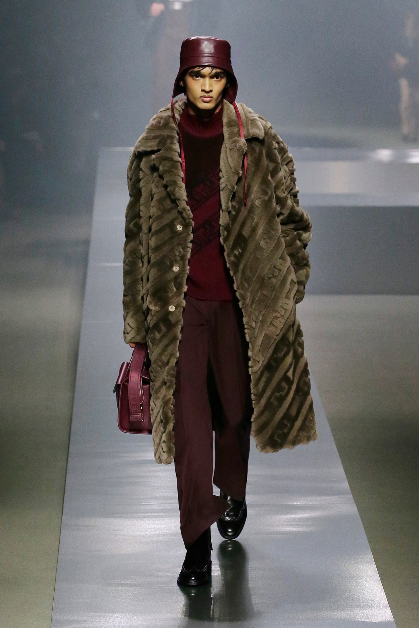 A model walking the runway at Fendi AW22