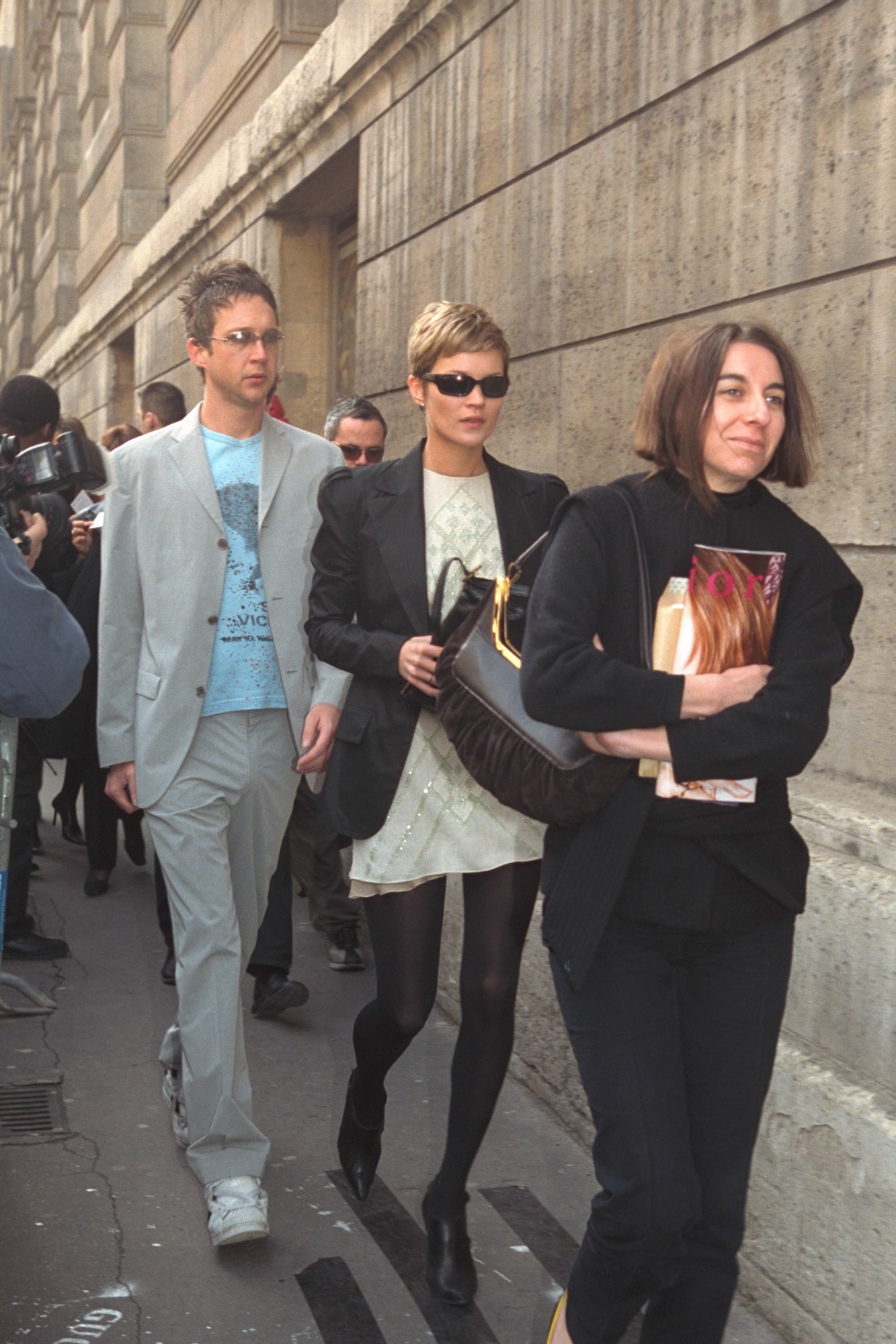 kate moss wearing a pixie haircut and mini dress at paris fashion week 2001