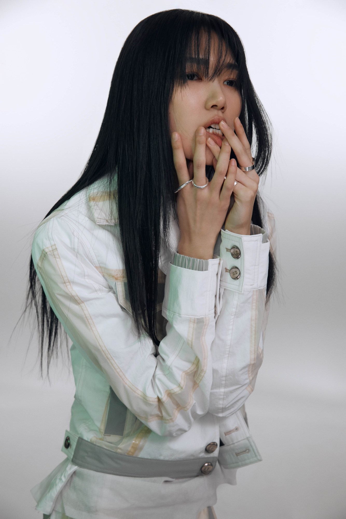 a model wears a white fitted jacket with off-white detailing down the seams