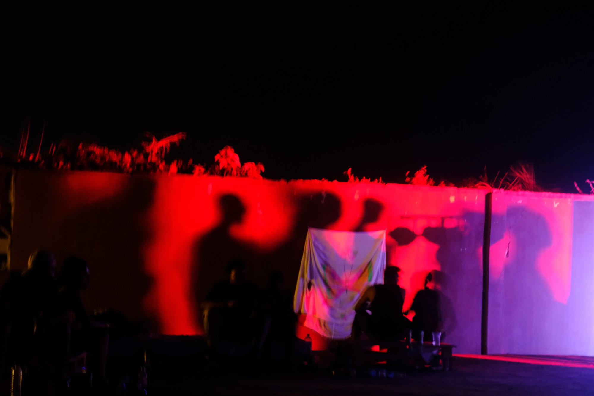 someone painting a mural on fabric outdoors at a party in Lagos