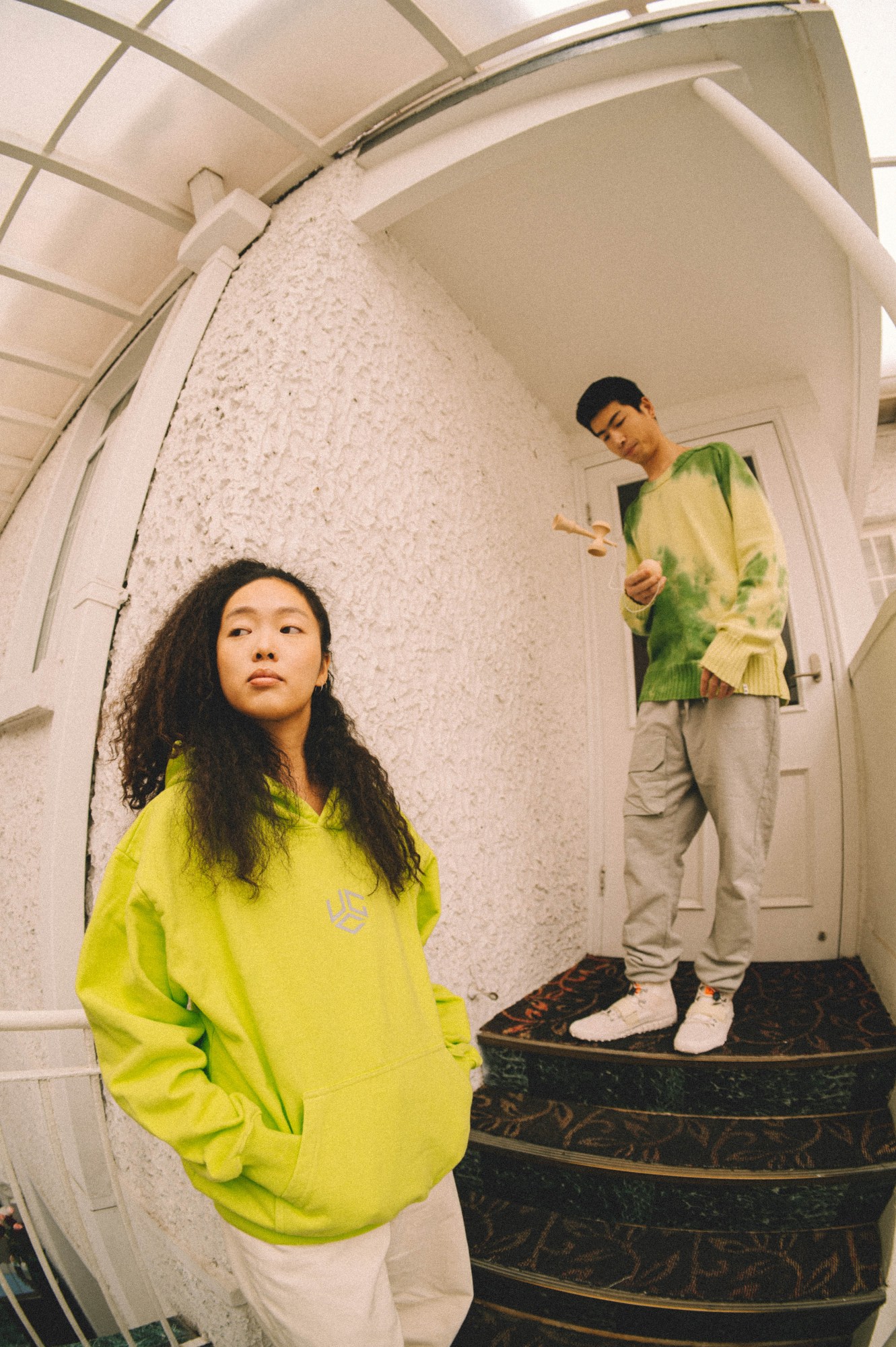 two models stand in a hotel corridor wearing UN GARCON CHARMANT AW22