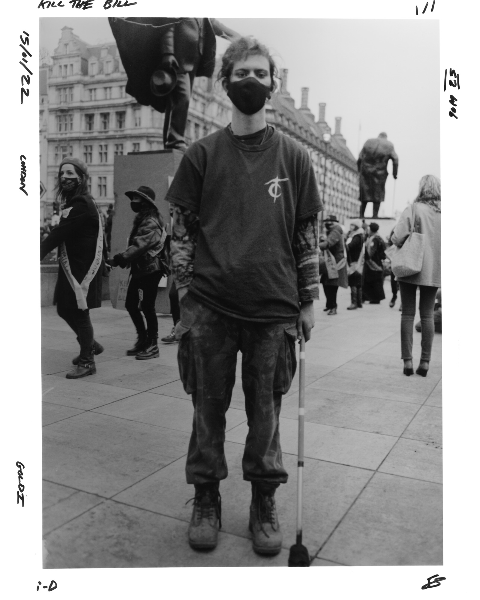 Protester in t-shirt and cargo trousers with a walking stick at the Kill the Bill protest