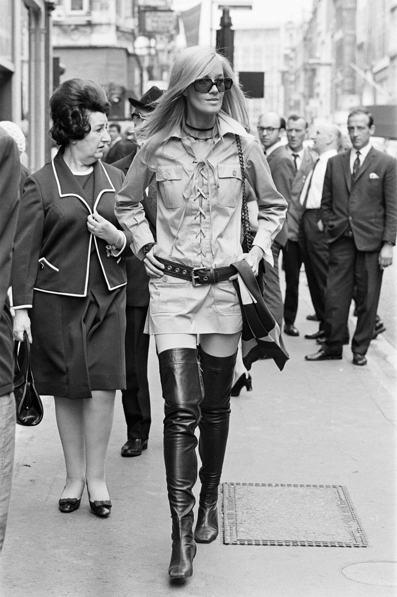 betty catroux walking down the street in tall lace up boots and a saint laurent shirt dress