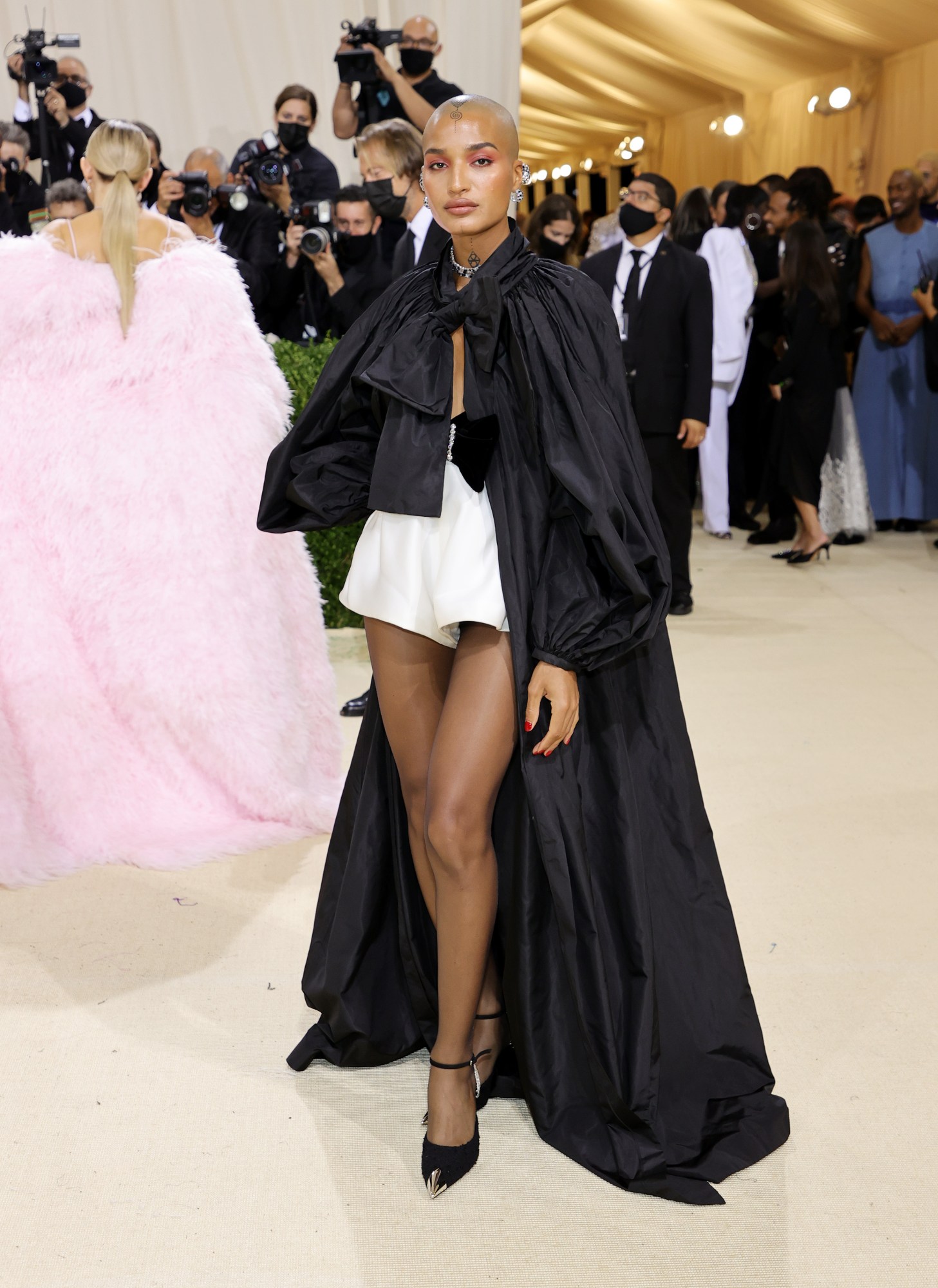 indya moore posing in a saint laurent cape at the met gala