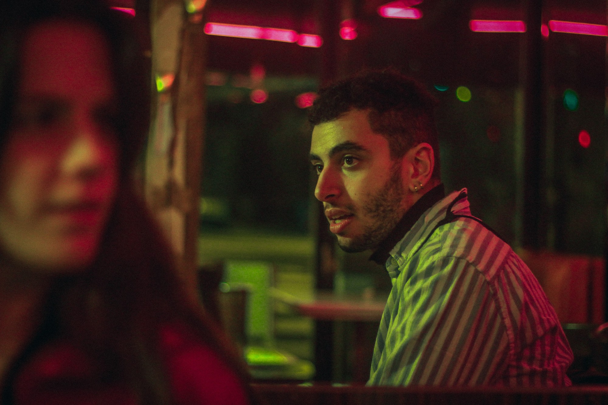 A man and a woman sitting at a bar table