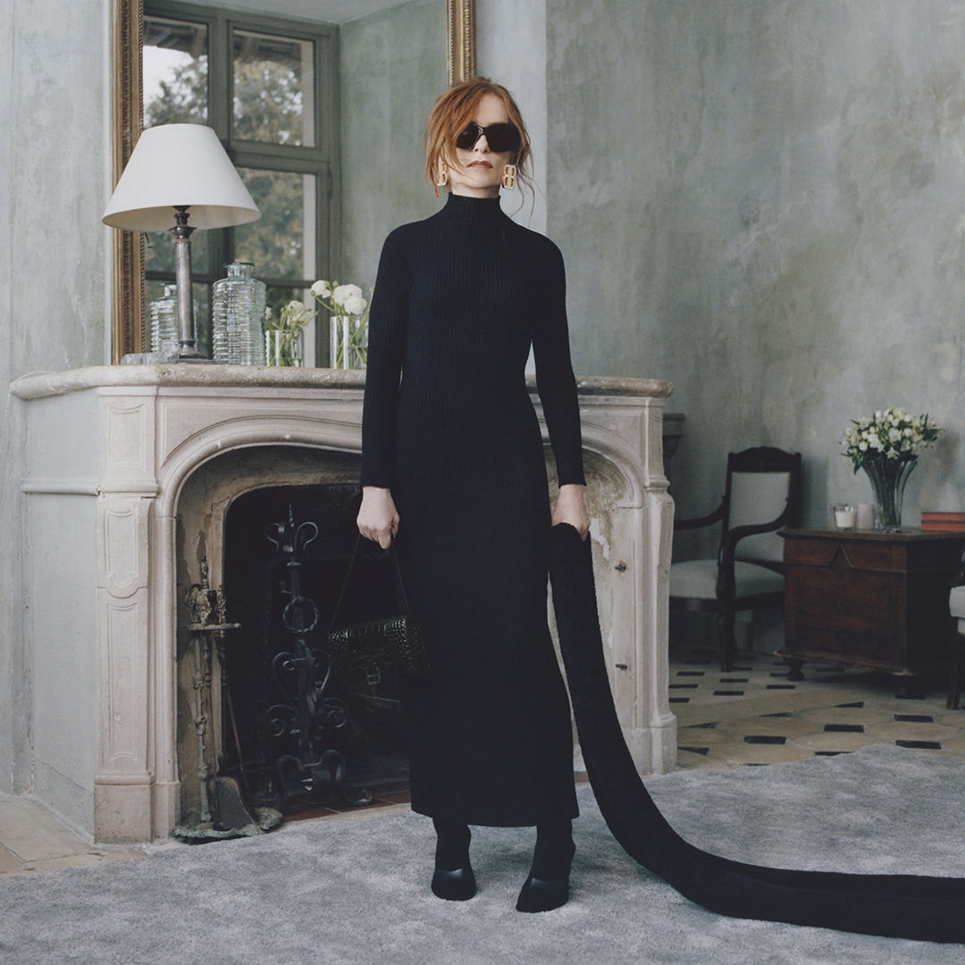 Isabelle Huppert wearing Balenciaga's hourglass dress in her home.