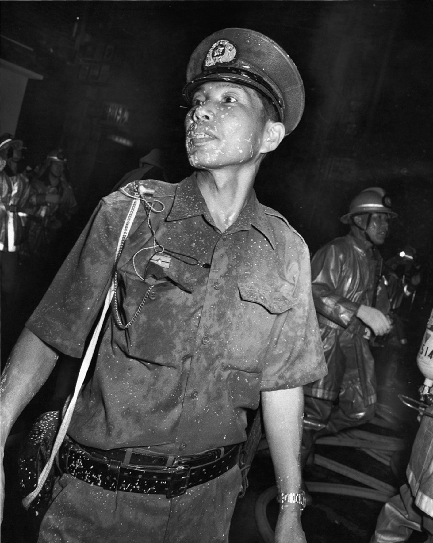 a police officer photographed in a dirty uniform in 70s tokyo by seiji kurata