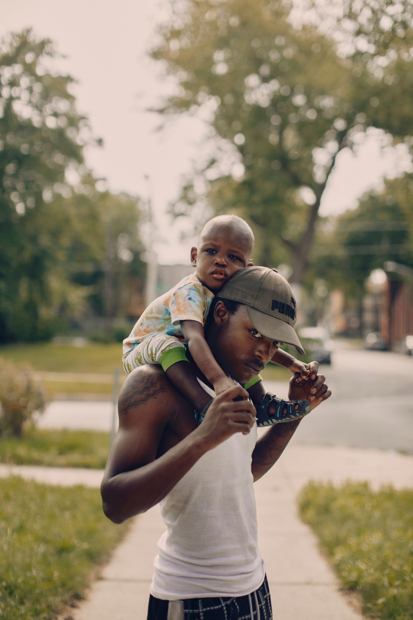 a man holds a child on his shoulders