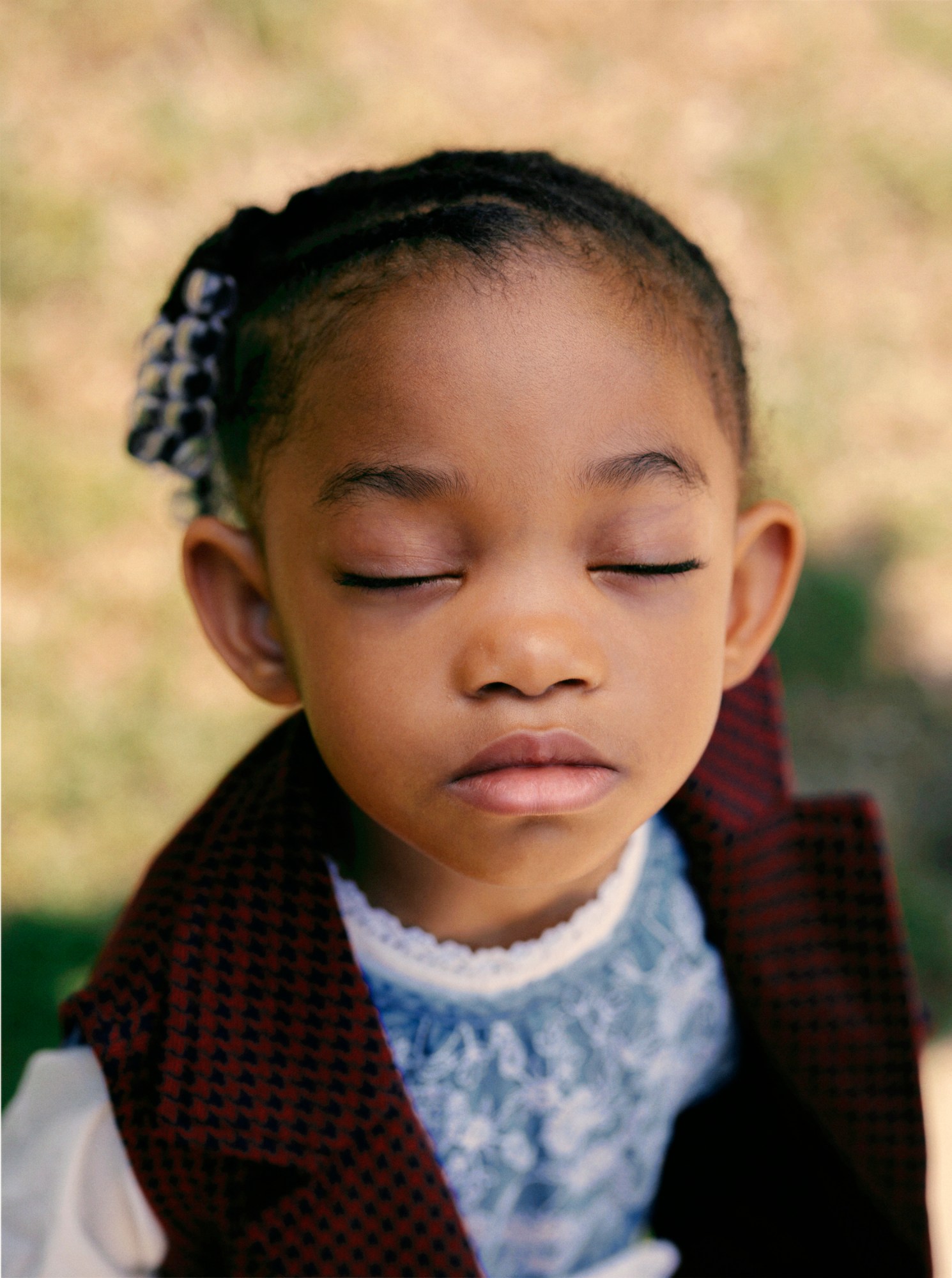 a young girl with her eyes closed