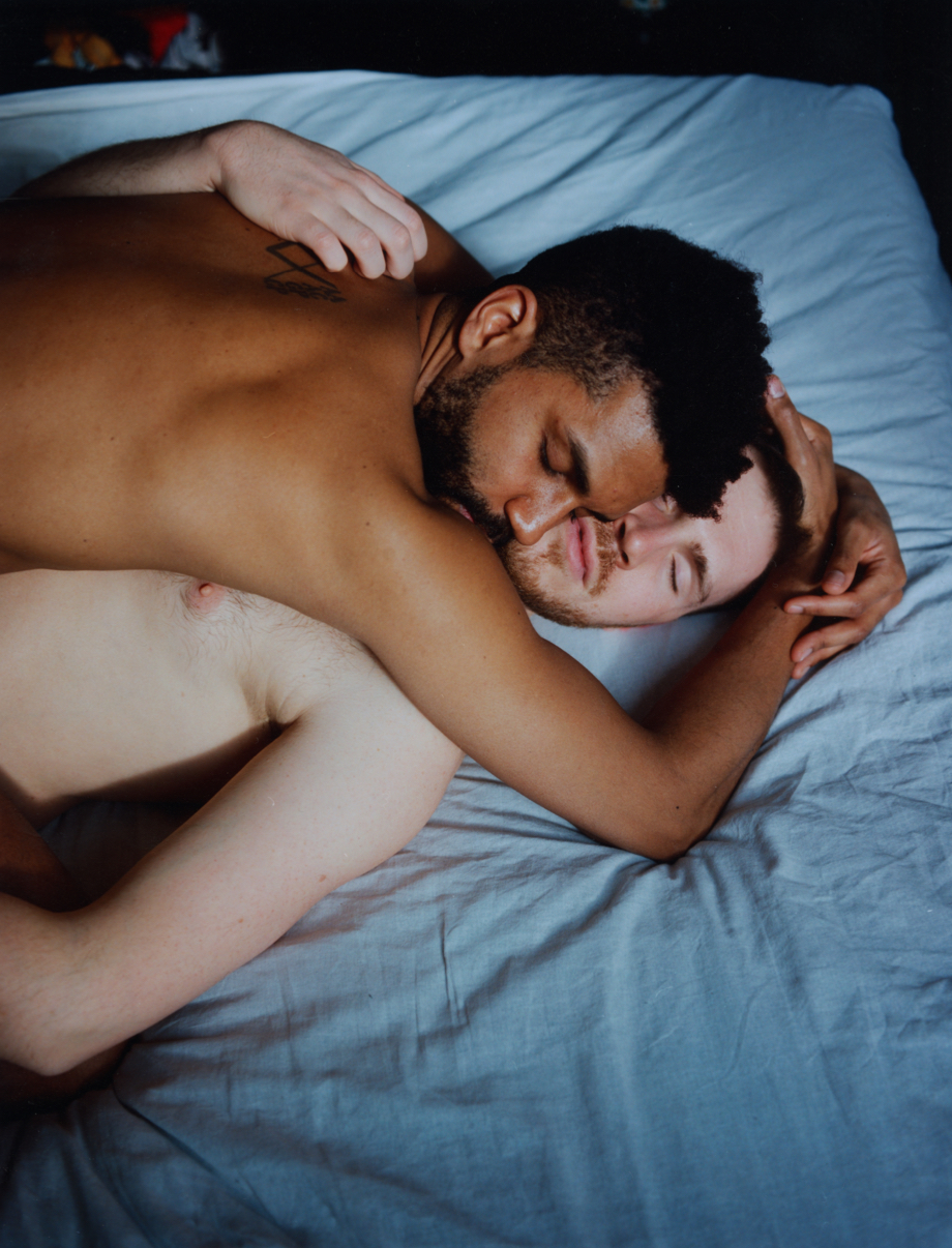 a couple embrace in bed