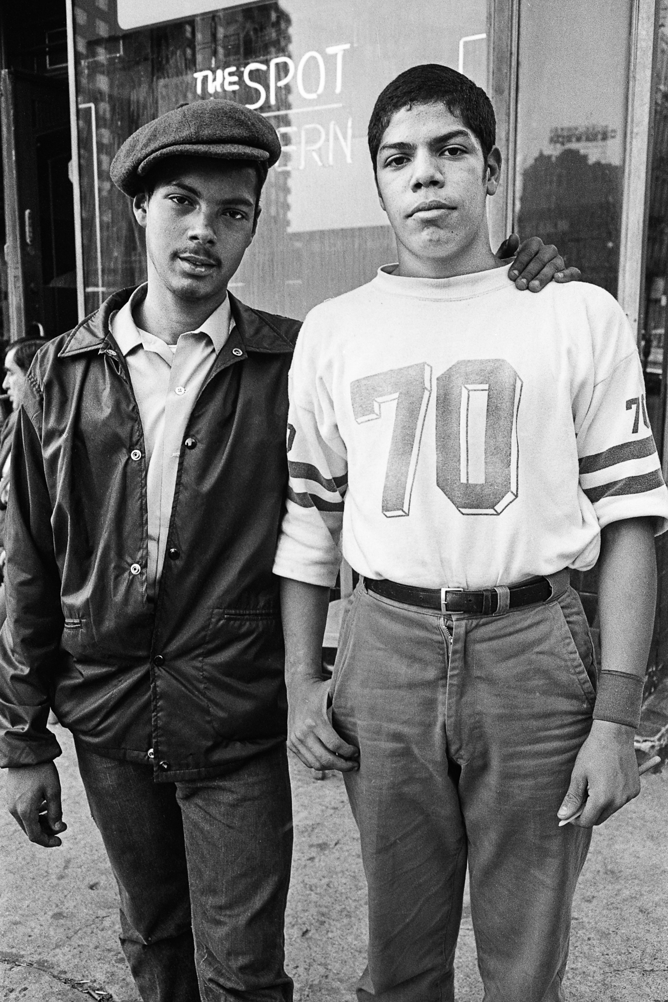 Black and white photo of teenage boys holding shoulders